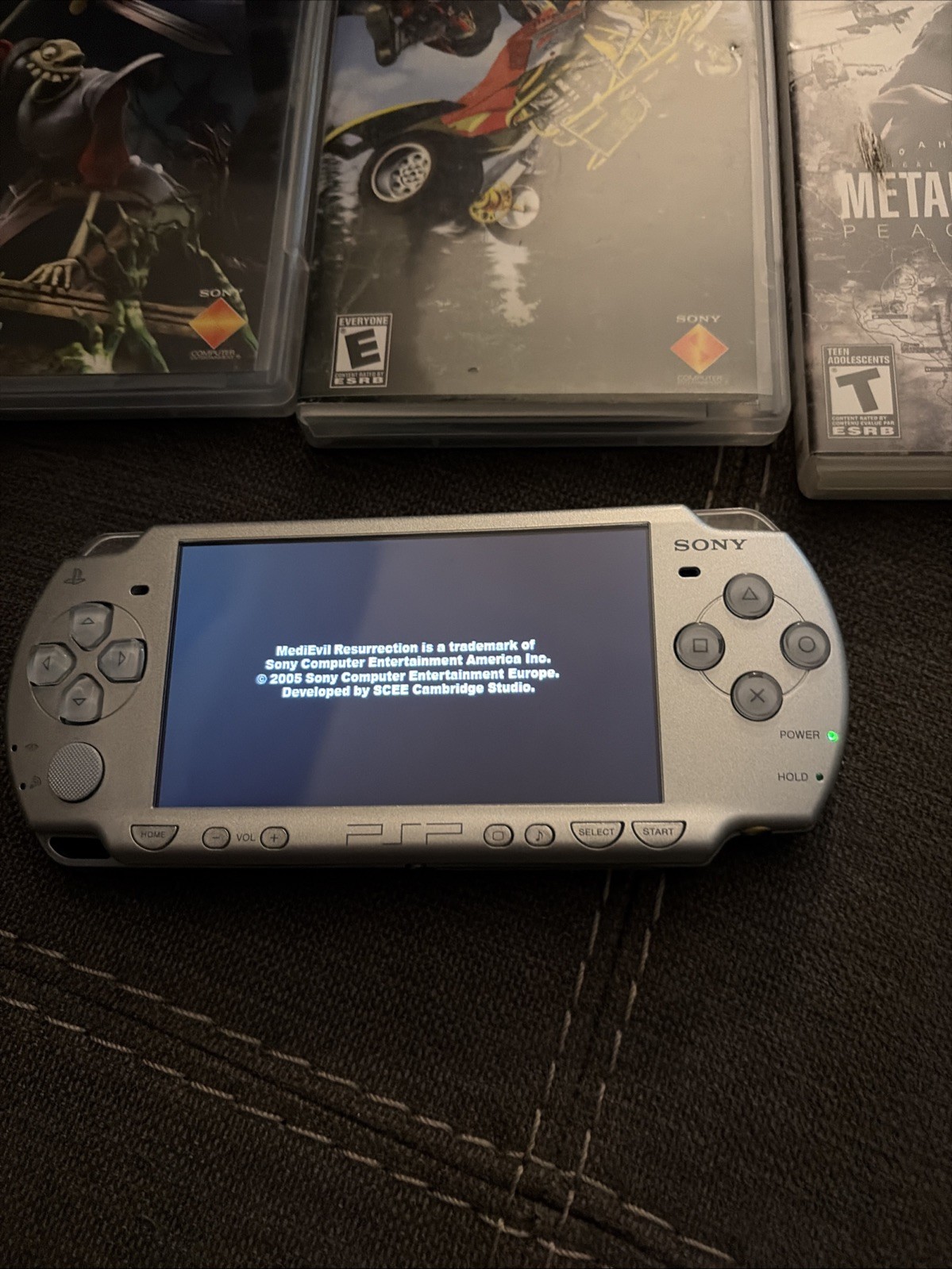 Sony PSP 2001 Handheld Console System Silver with 3 games and 1 movie.
