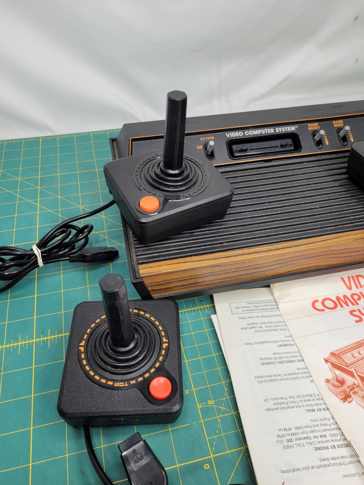 Atari 2600 console With Cords And 4 Joystick Controllers Powers On Needs Work