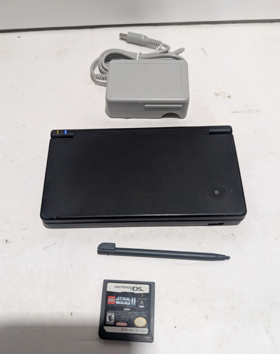 Nintendo DSi Black Console + Charger + Stylus + LEGO Star Wars II–Tested Working