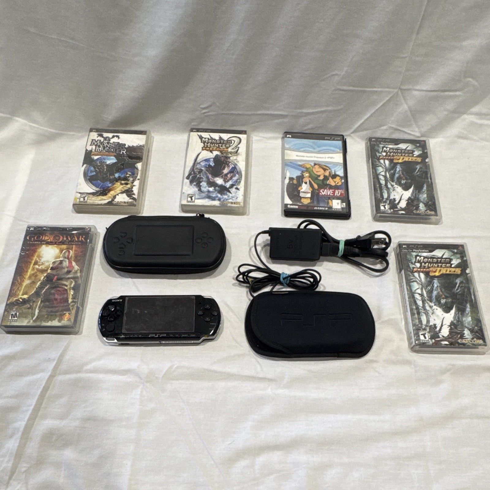 Sony PSP-1001 Black Handheld Console w/ Case, Charger & Game 6 UMD Bundle