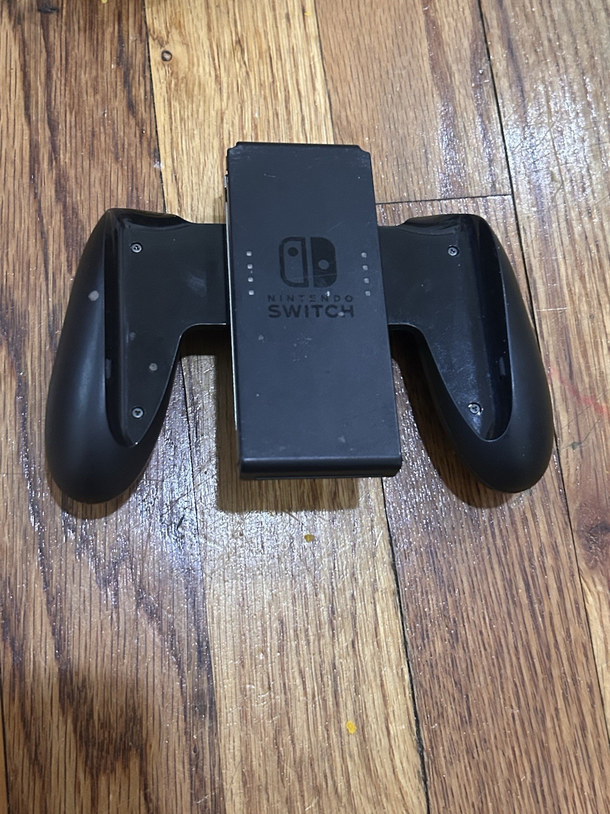 Nintendo Switch with joycon controllers, a charger, 4 games, and a game case.
