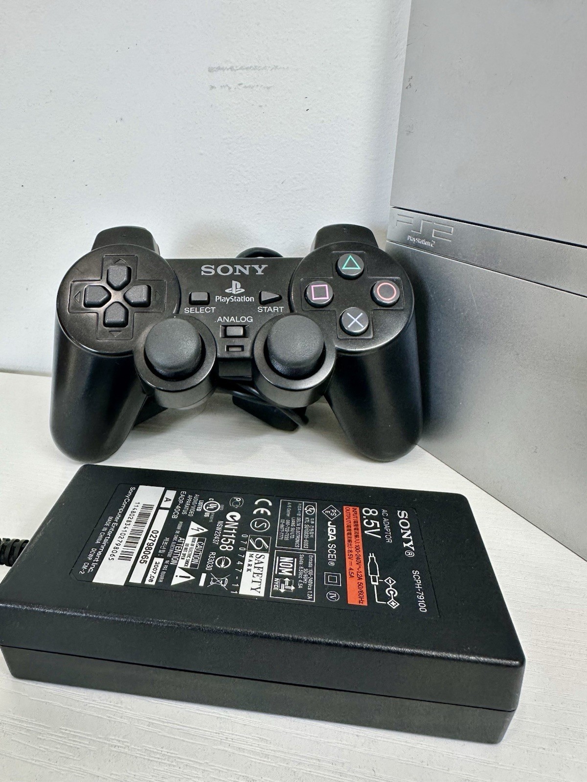 Silver PlayStation 2 Slim OEM Bundle – OEM Controller, OEM Cables, Memory Card