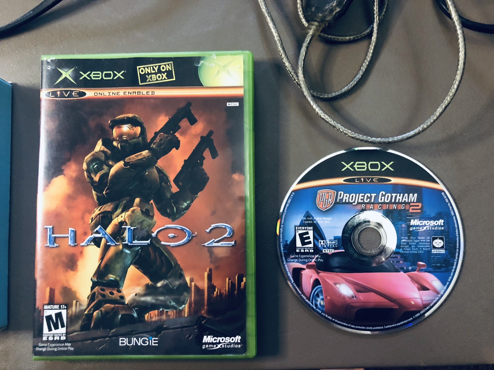 Xbox console, three controllers, carryting case, 2 games, and more
