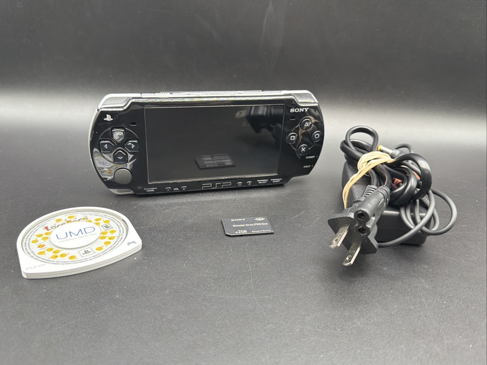 PSP 2001 Console W/Memory Stick 2GB AND CHARGER Working/ tested. W/ Loco Roco