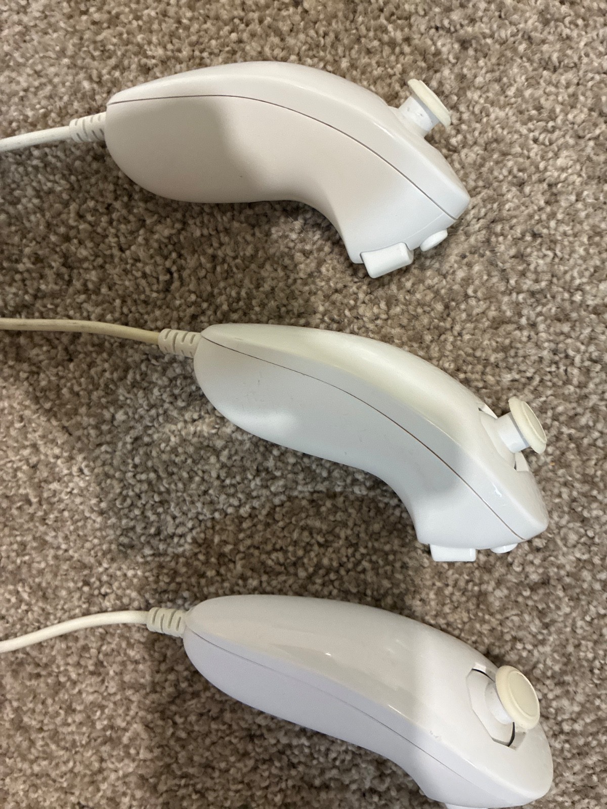 Nintendo Wii console, three controllers, four nunchucks, Wii steering wheel