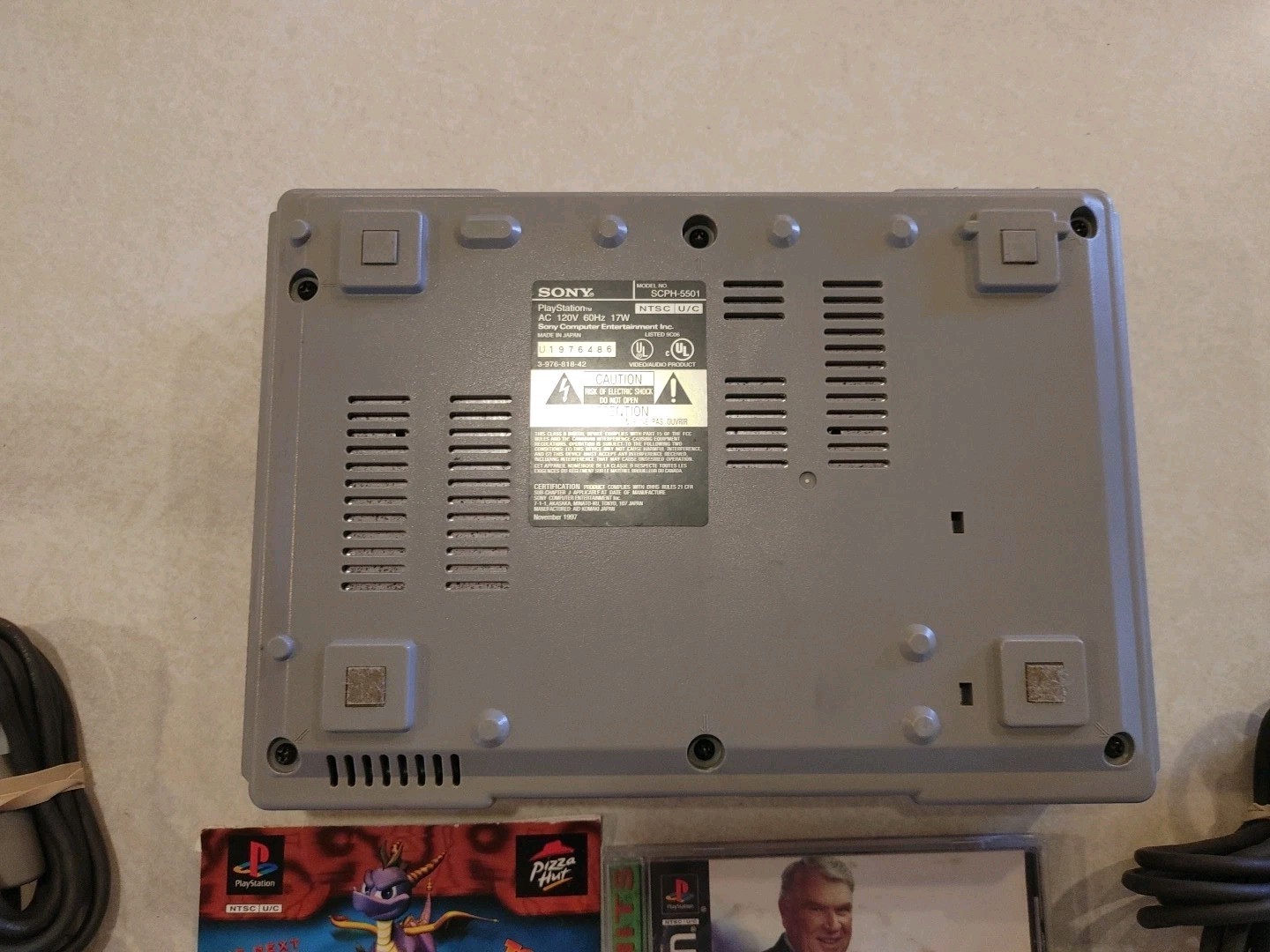 Sony PlayStation Console with two controllers and games
