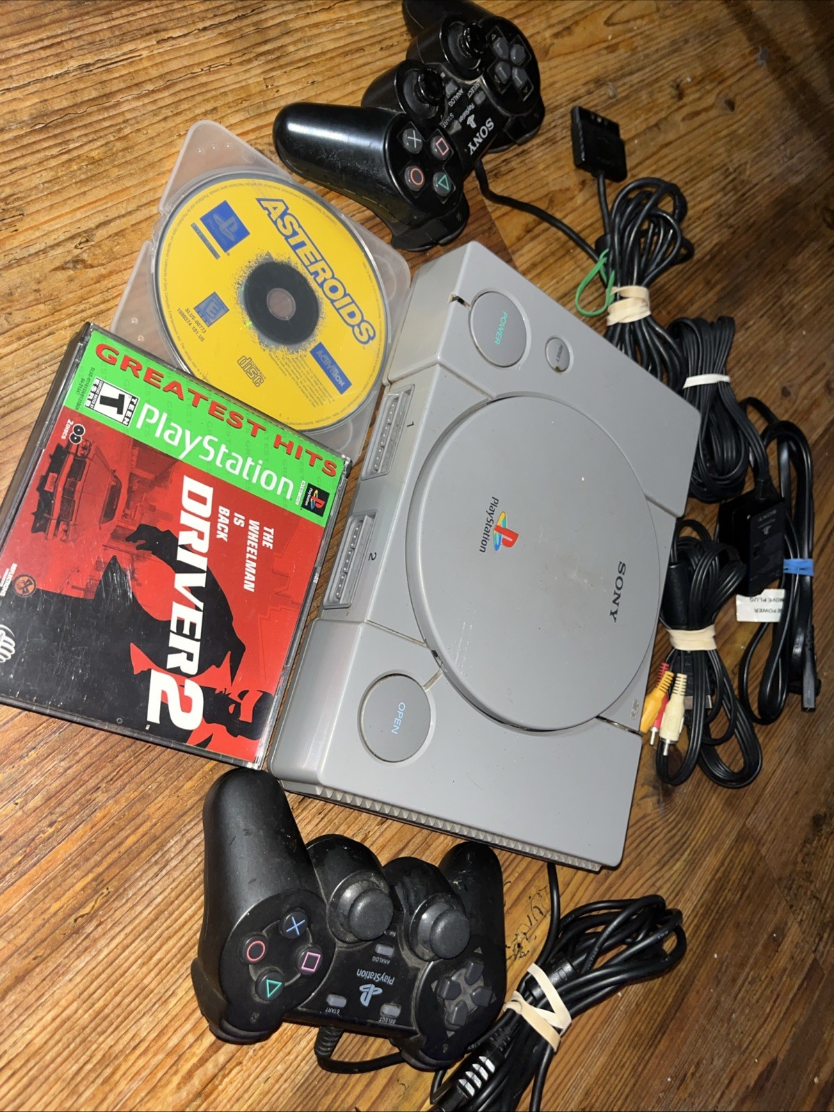 Sony Playstation 1 Gray Console With Games Controllers, A/V Cable, and Power