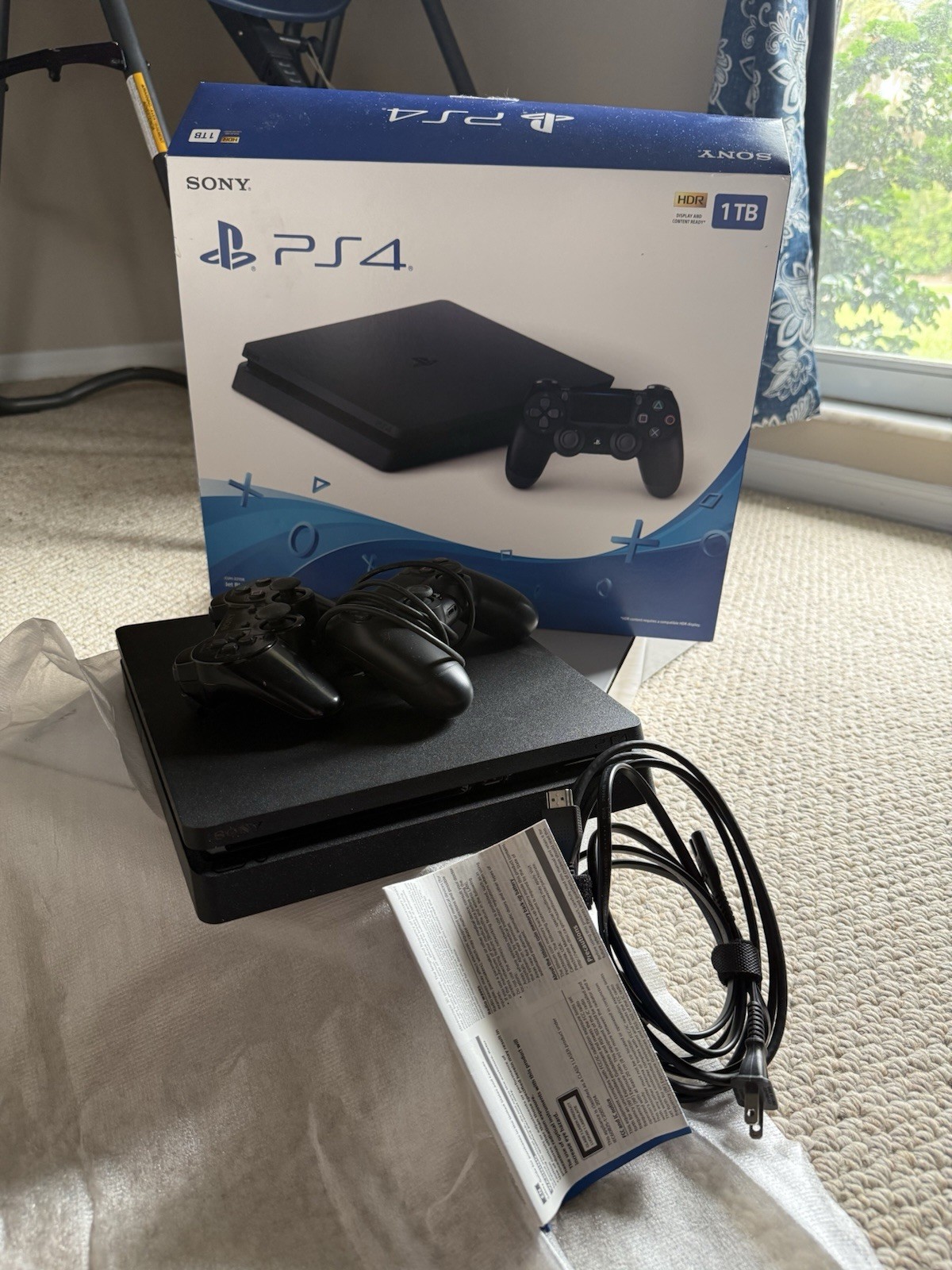 Sony PlayStation 4 Slim Jet Black, 500GB with 2 controllers (1 older model).