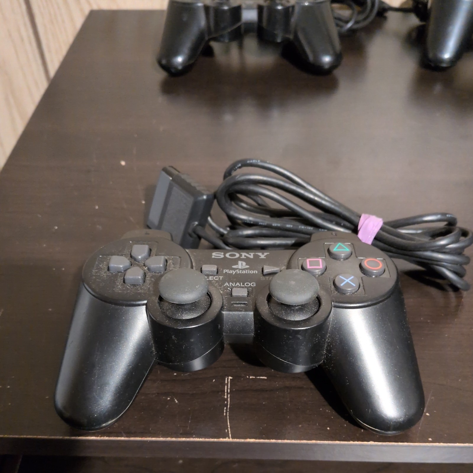2 Sony PlayStation Consoles (w/Controllers, Cable, & 2 8MB Memory Cards)