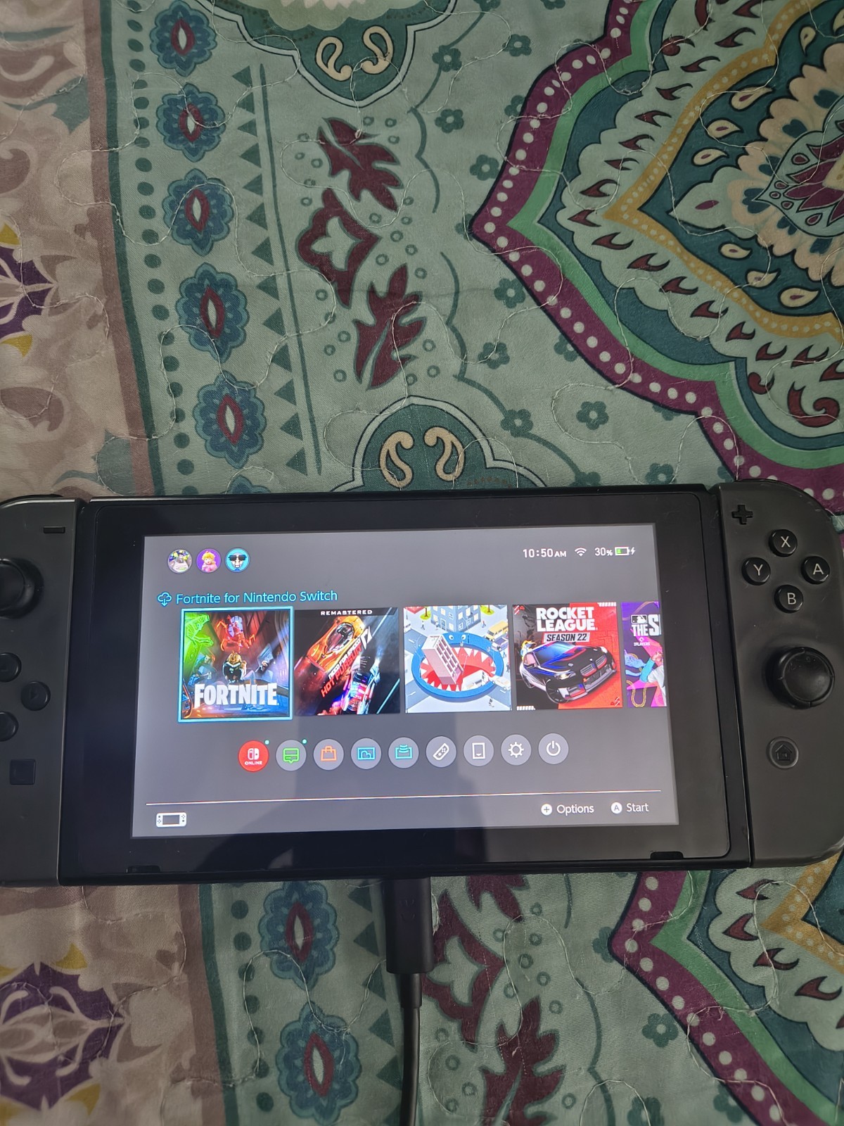 Nintendo Switch with joycon controllers, a charger, and a game case.