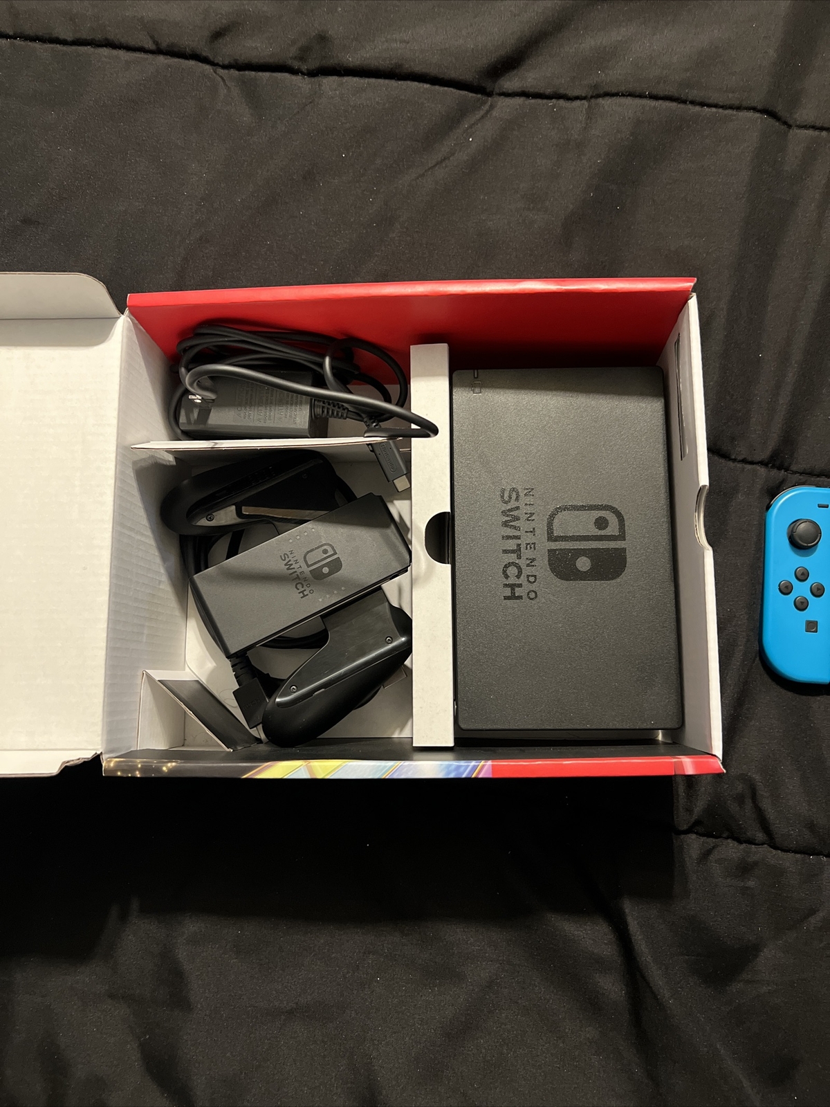 Nintendo Switch Blue and Red Joy-Con Controllers and Mario Kart 8