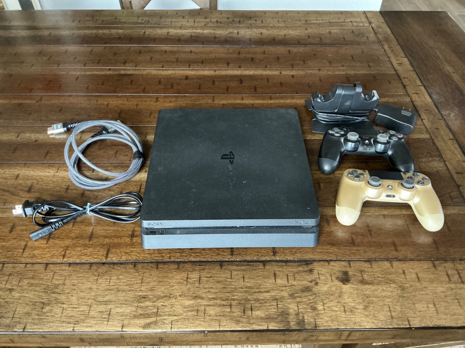 Sony PlayStation 4 Slim Console, two Controllers, Controller Dock and cables
