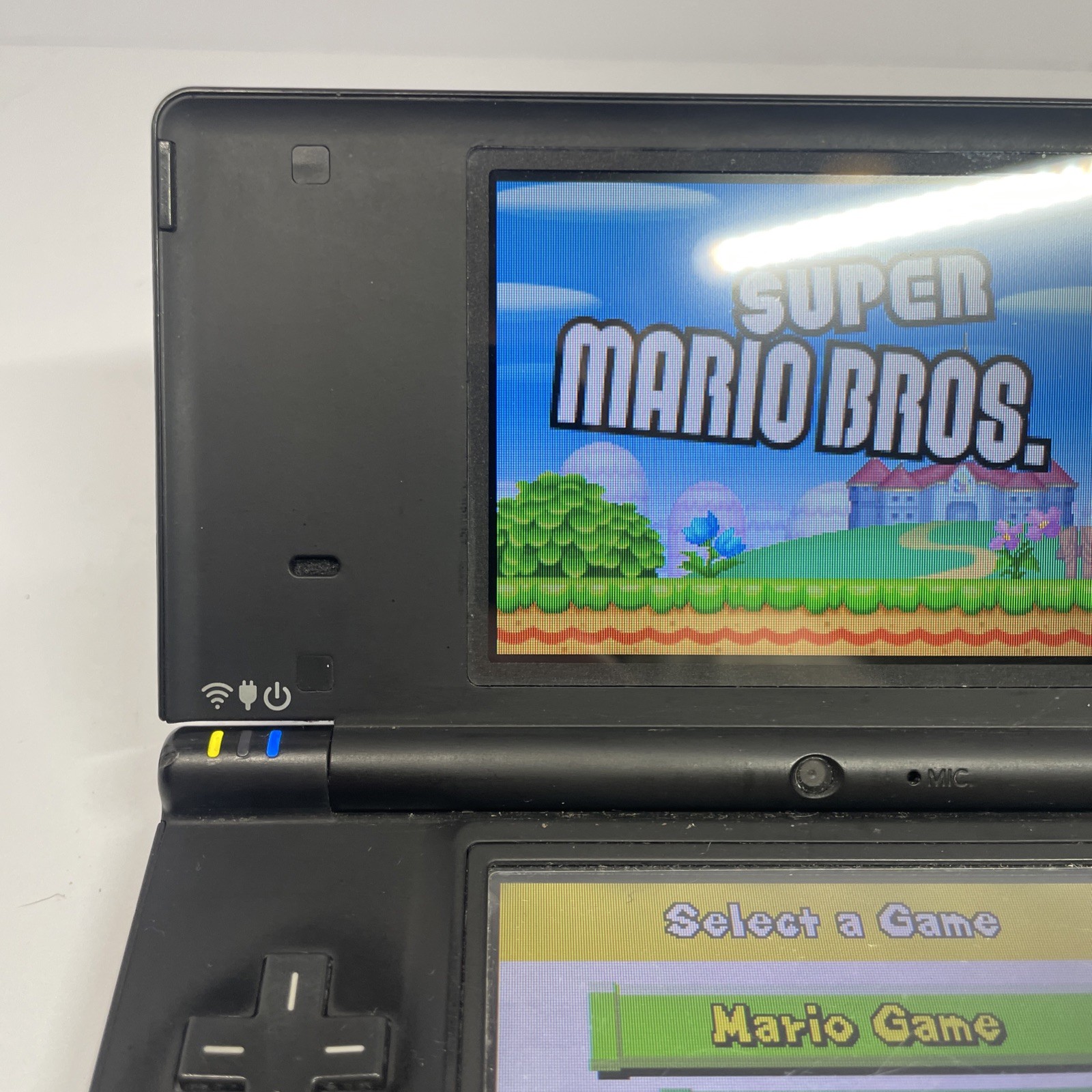 Nintendo DSi TWL-001 Black handheld system w/ Mario Bros -needs charger