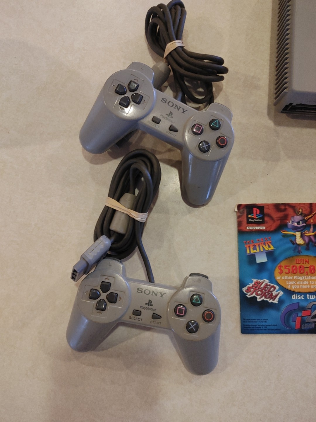 Sony PlayStation Console with two controllers and games