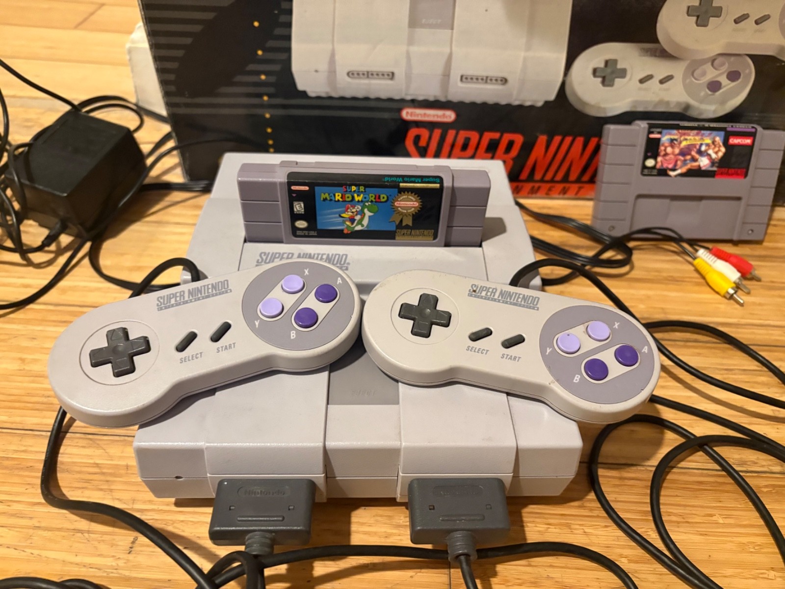 Super Nintendo Console with box and two games, two controllers & manual