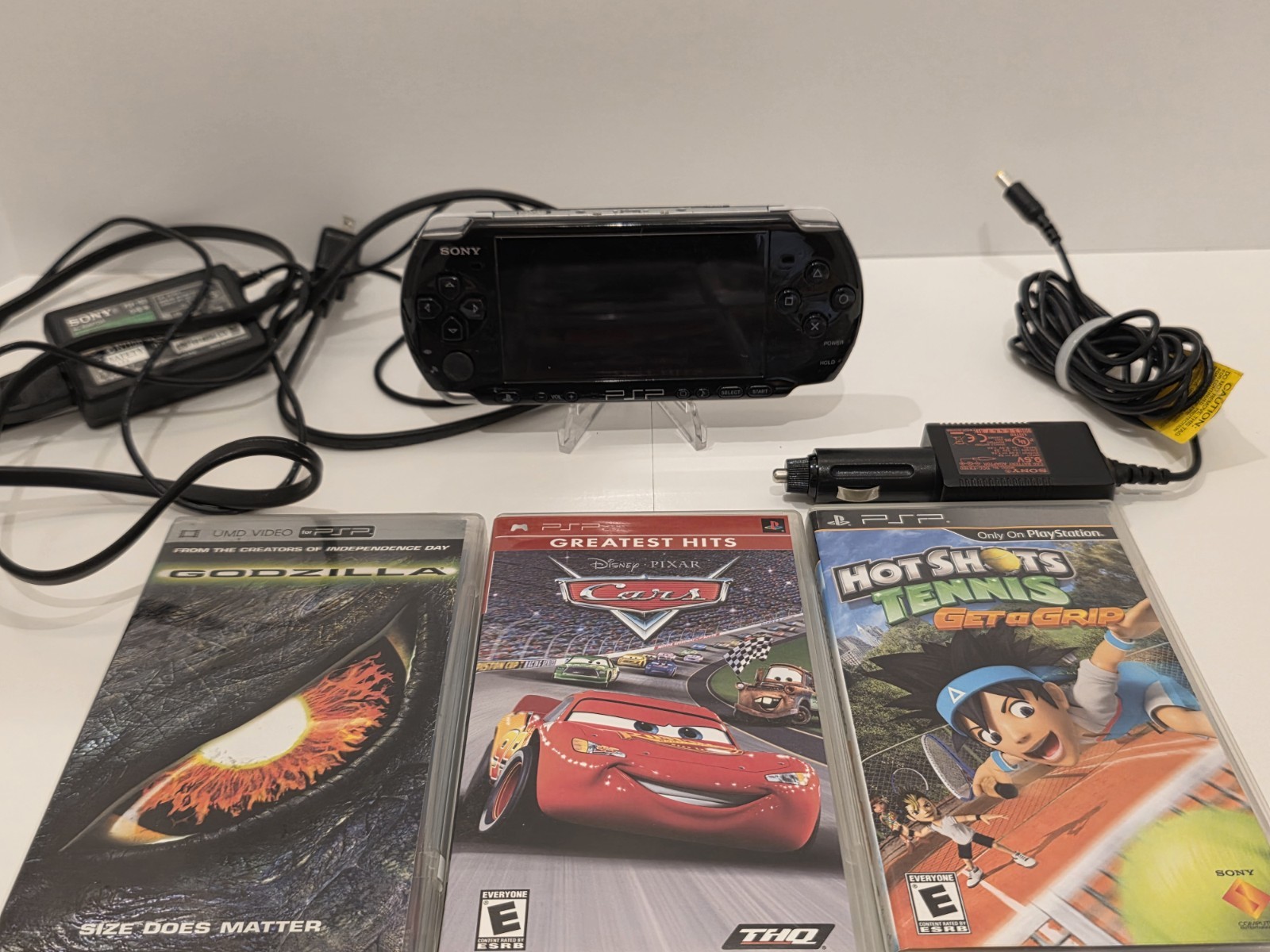 Sony PSP 3001 Black Handheld Console with Charger, Car Adapter, and 5 Games.