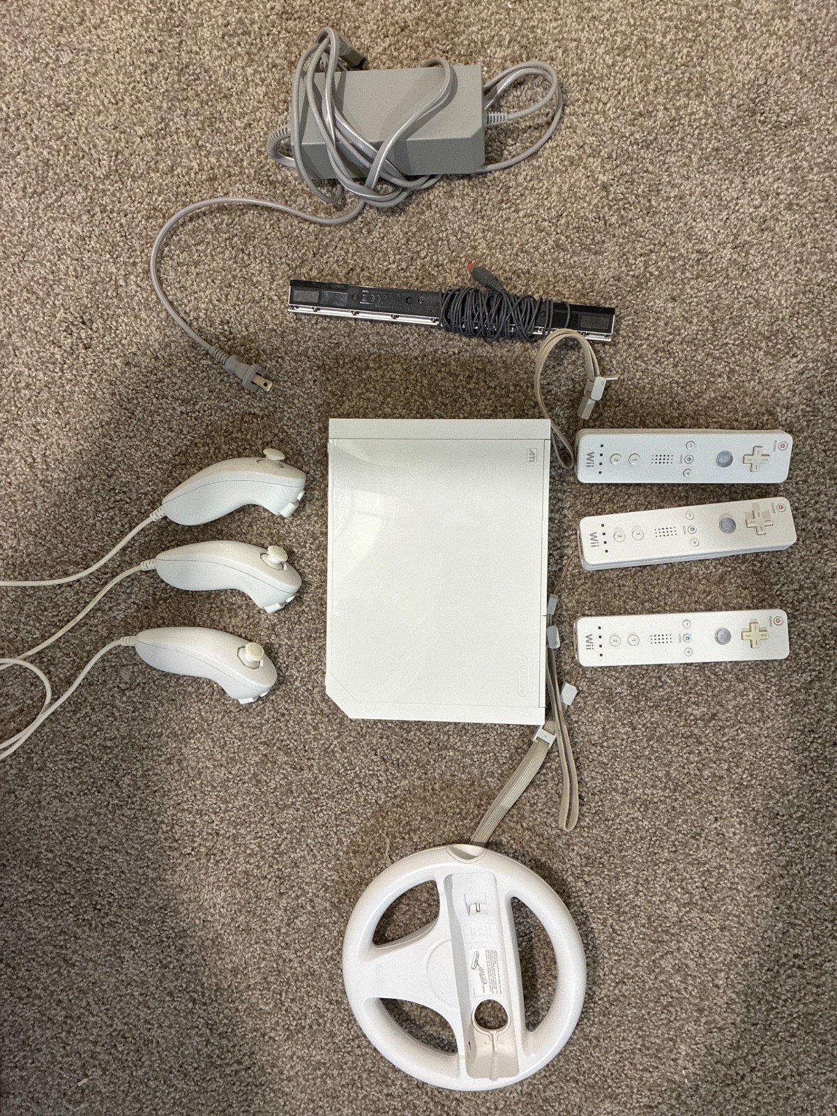 Nintendo Wii console, three controllers, four nunchucks, Wii steering wheel