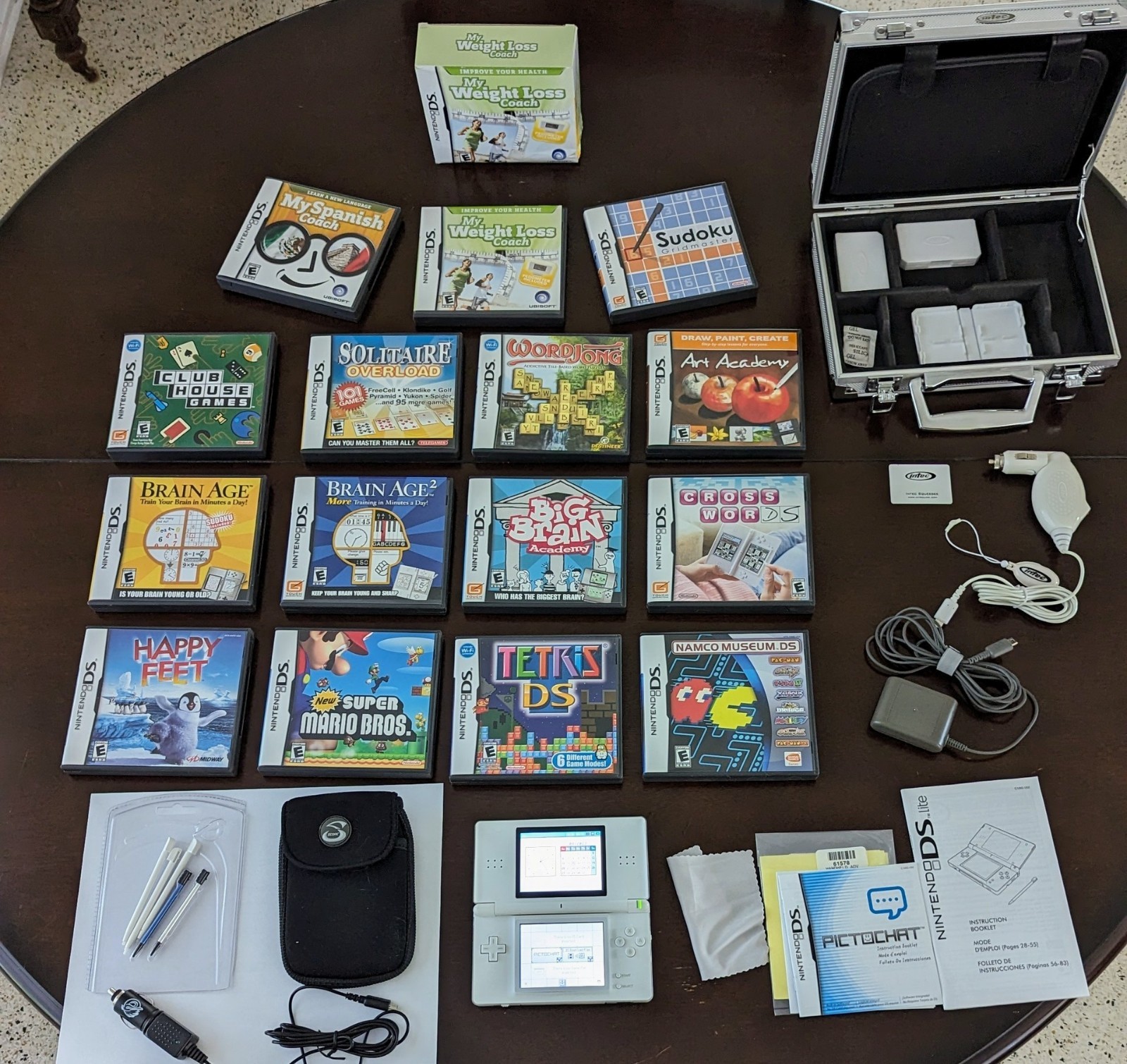 Nintendo DS Lite with Charger, Hard Case, soft case, 15 games in cases.
