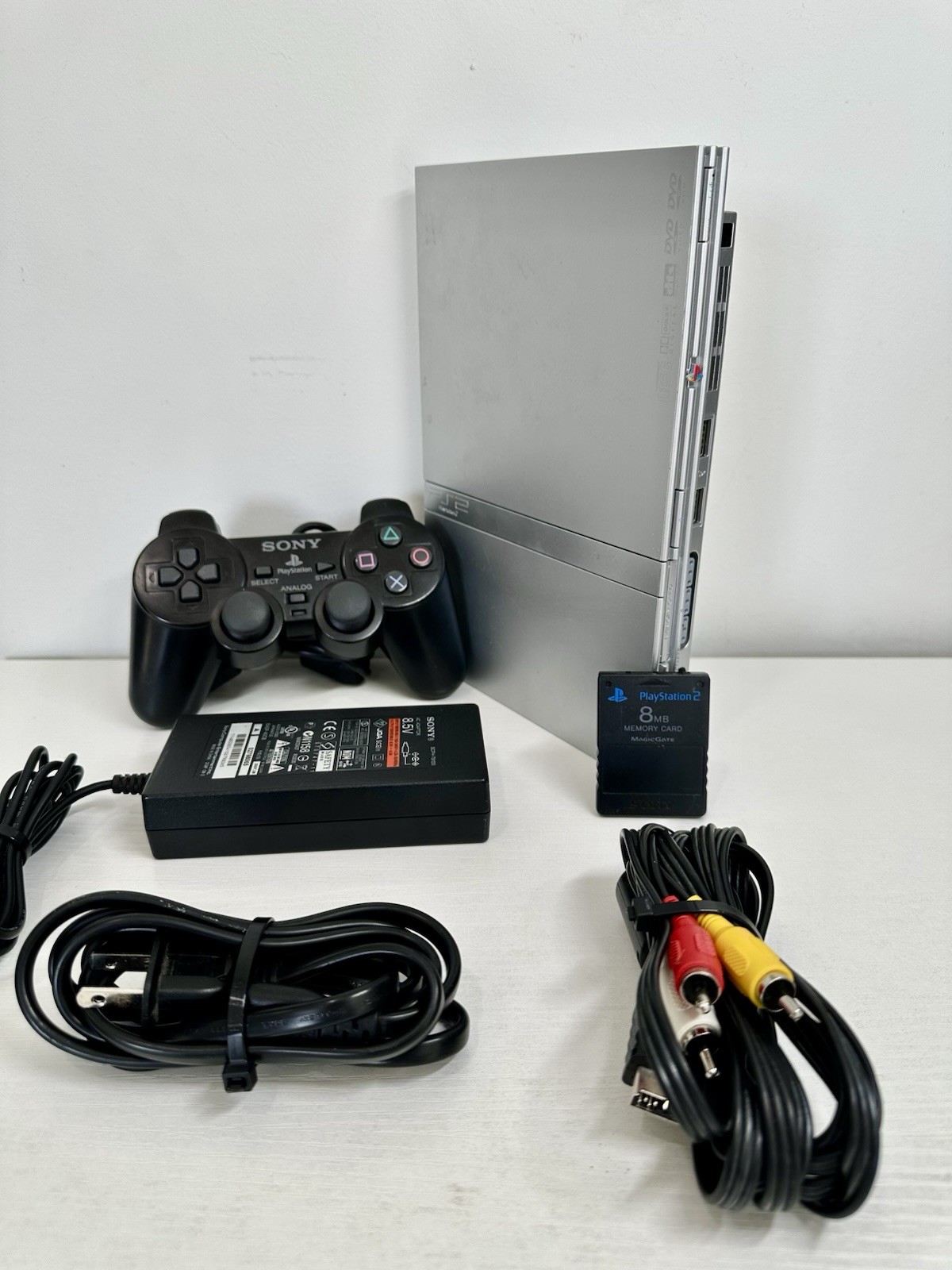 Silver PlayStation 2 Slim OEM Bundle – OEM Controller, OEM Cables, Memory Card