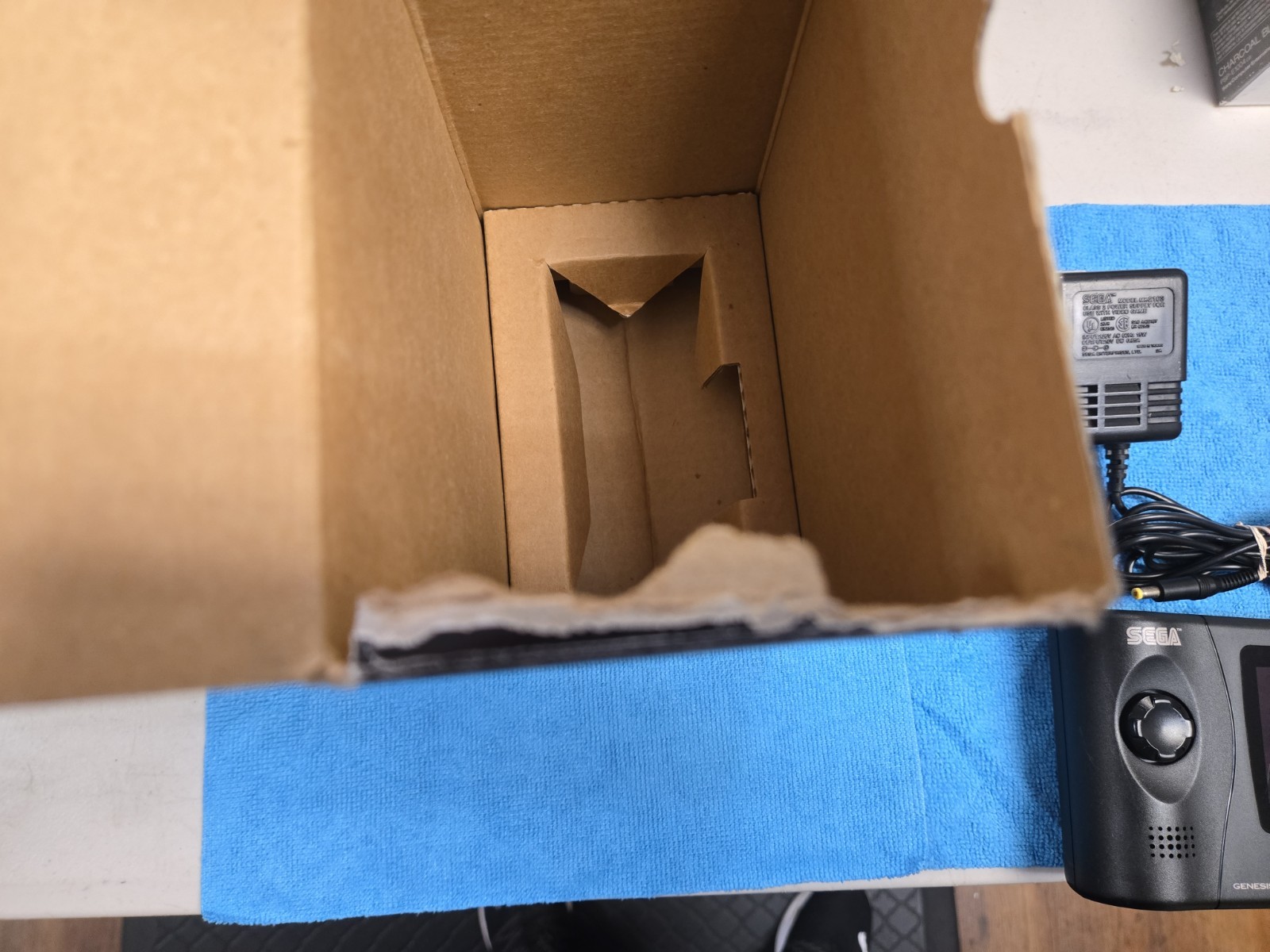 Sega Nomad Console. With Box (no inserts). A/C adaptor. Battery holder missing..