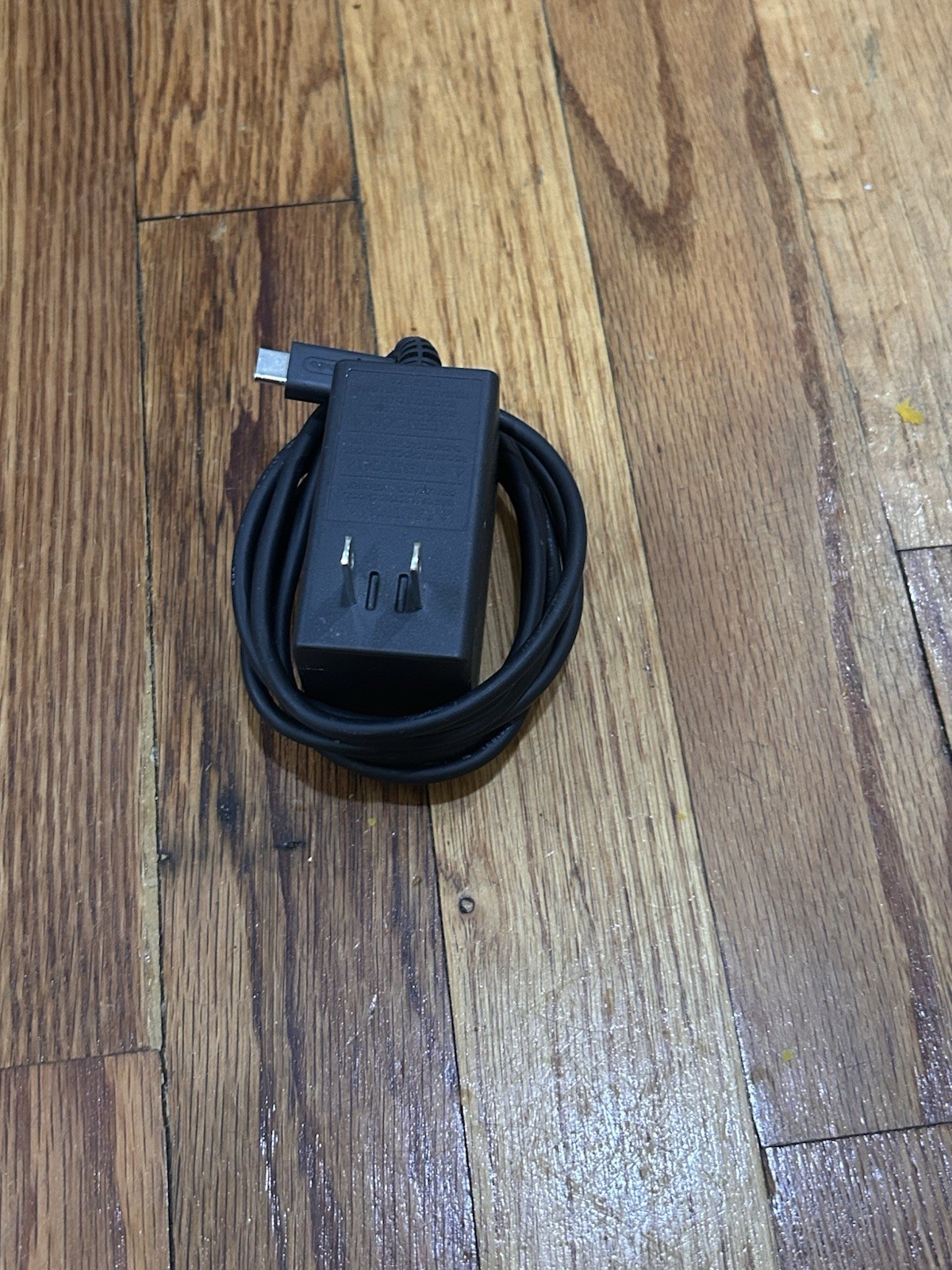 Nintendo Switch with joycon controllers, a charger, 4 games, and a game case.