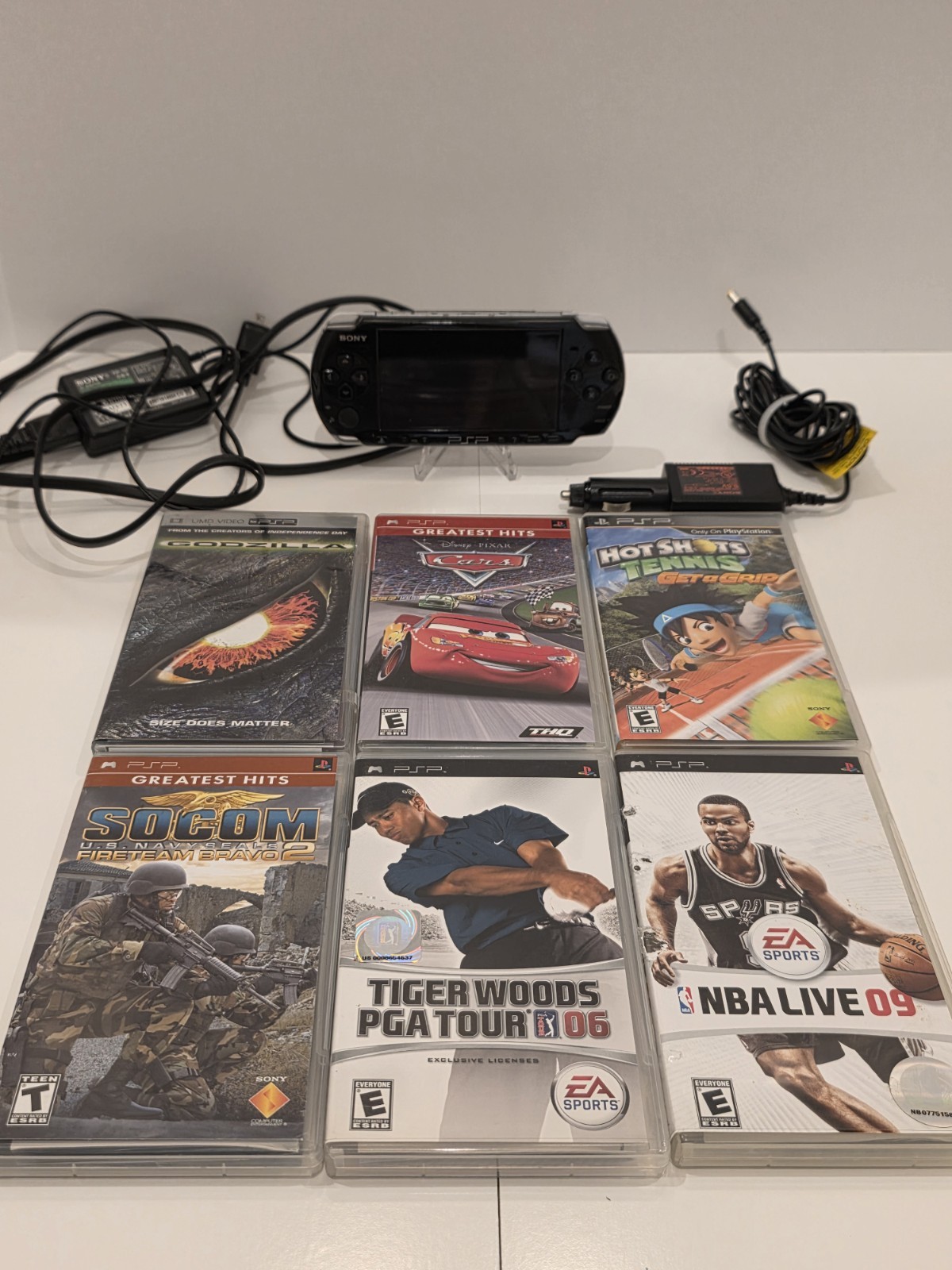 Sony PSP 3001 Black Handheld Console with Charger, Car Adapter, and 5 Games.