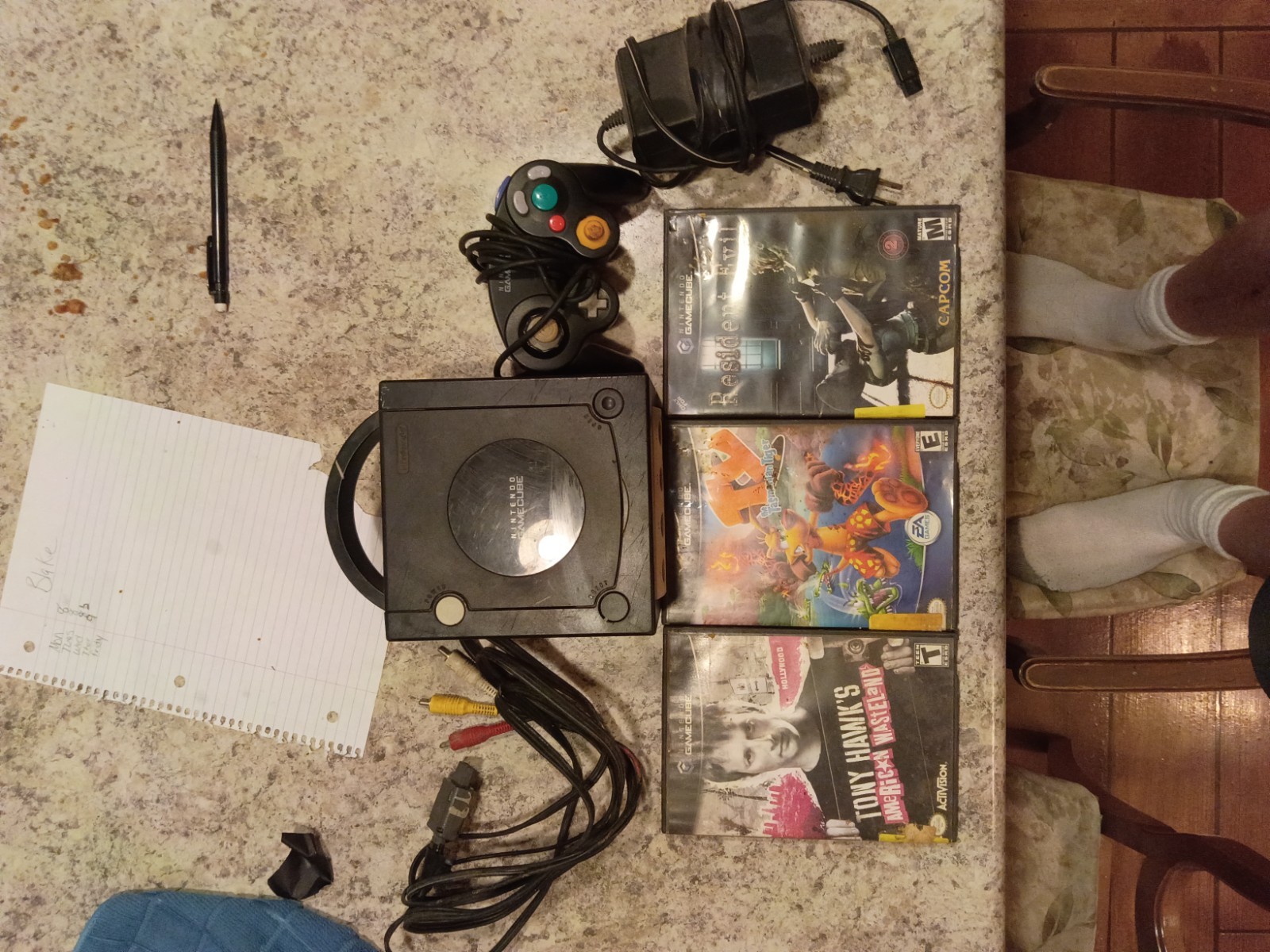 Used black Nintendo GameCube 5×5 with 3 games in medium condition works great