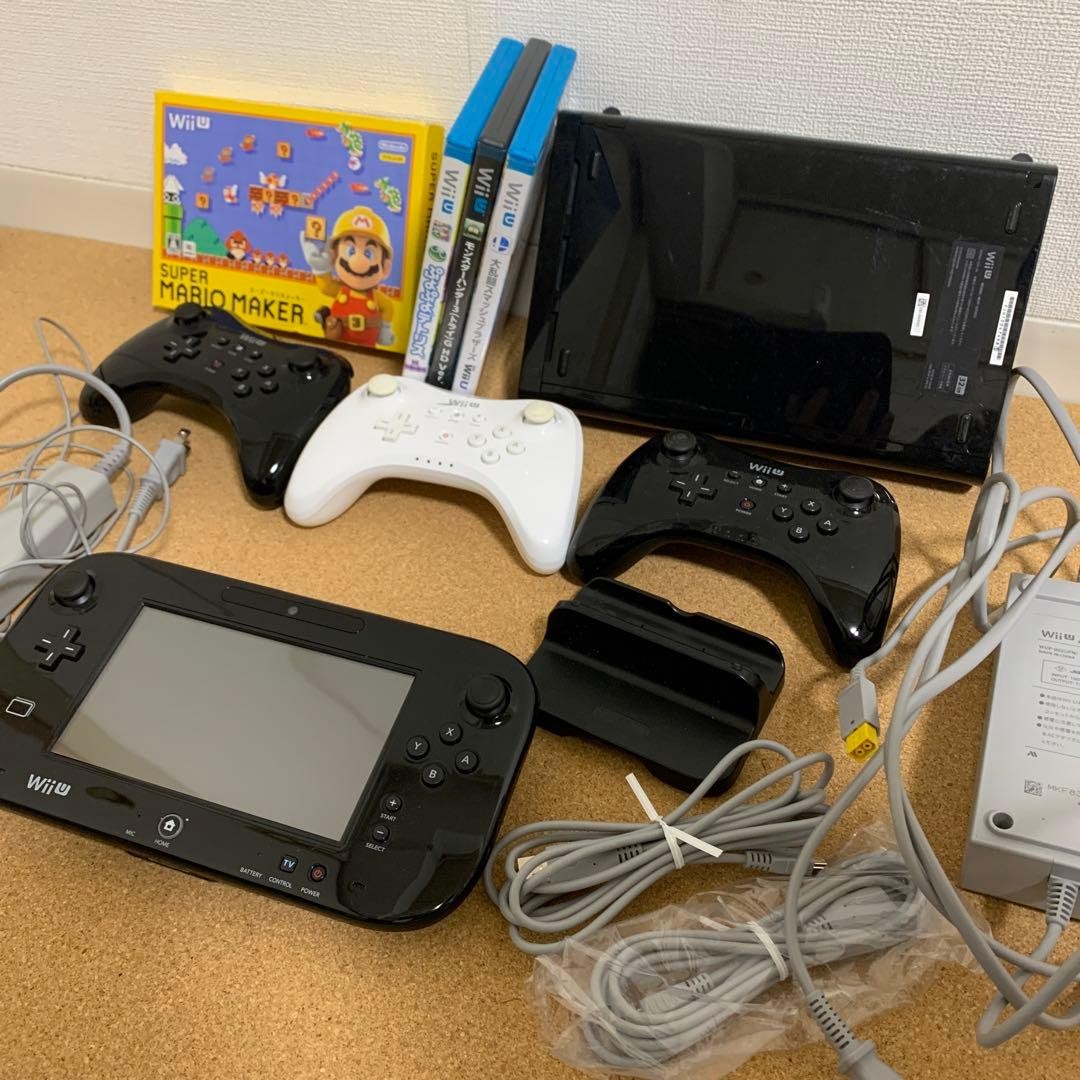 Three Nintendo WiiU Pro controllers and four games