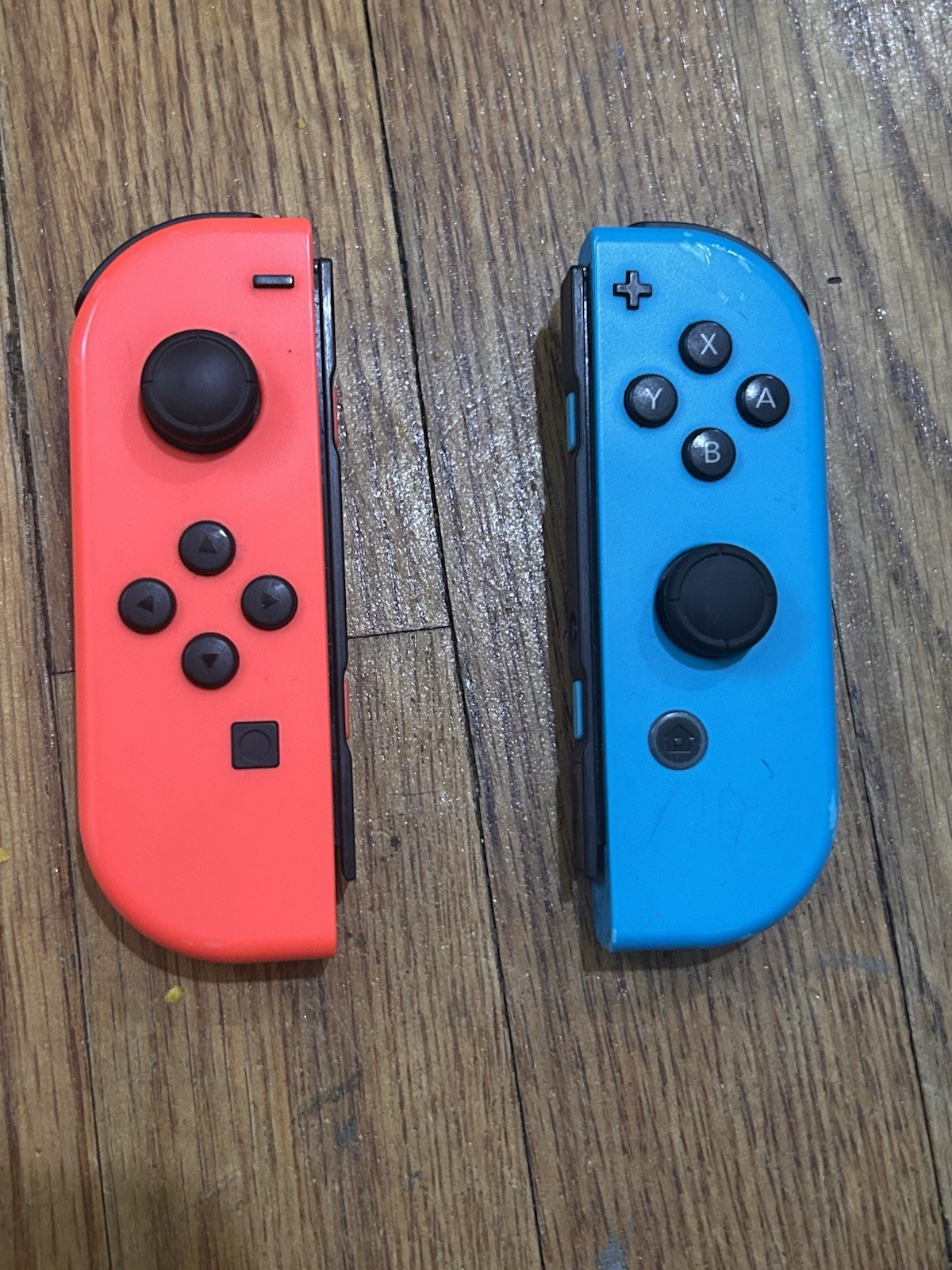Nintendo Switch with joycon controllers, a charger, 4 games, and a game case.
