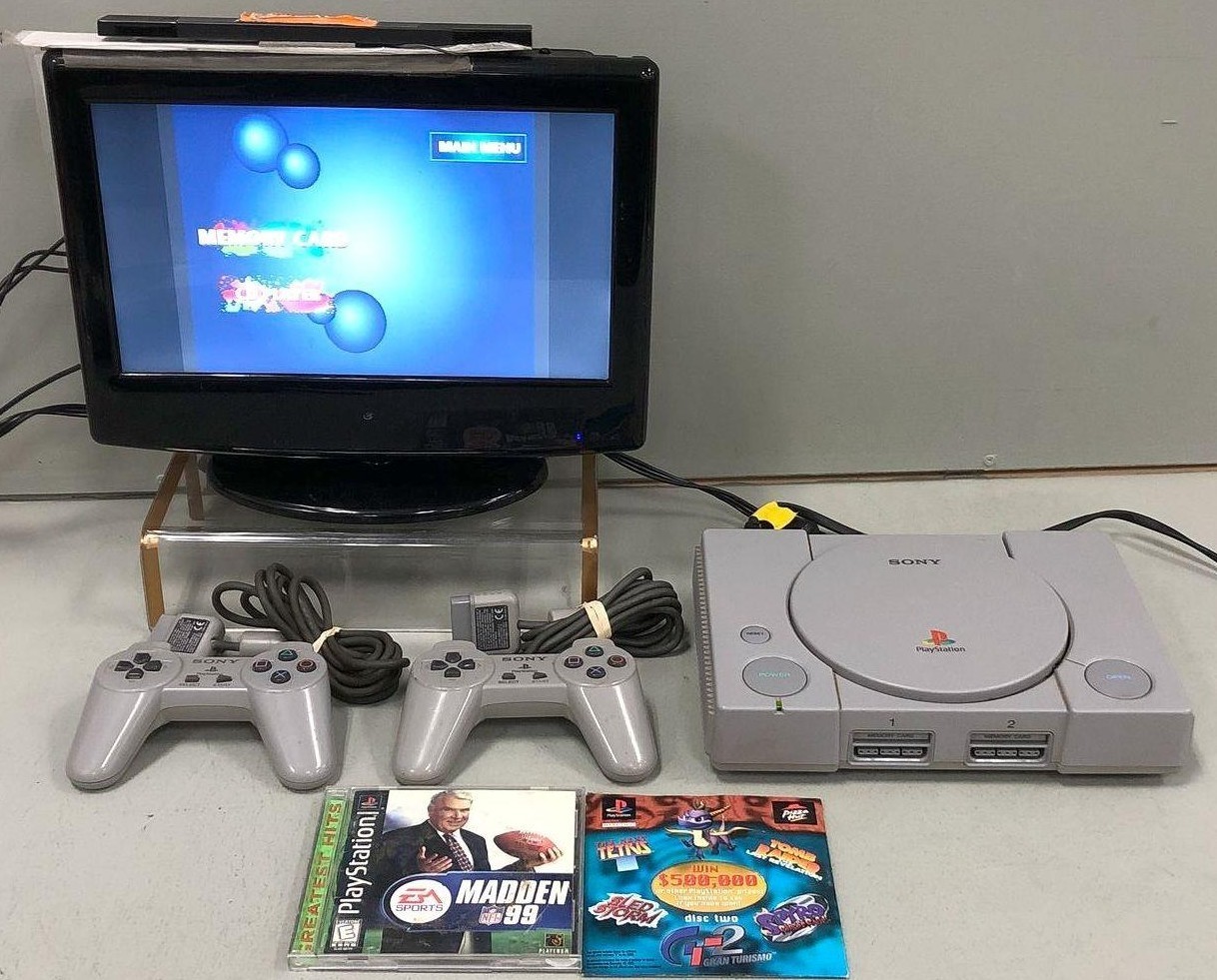 Sony PlayStation Console with two controllers and games