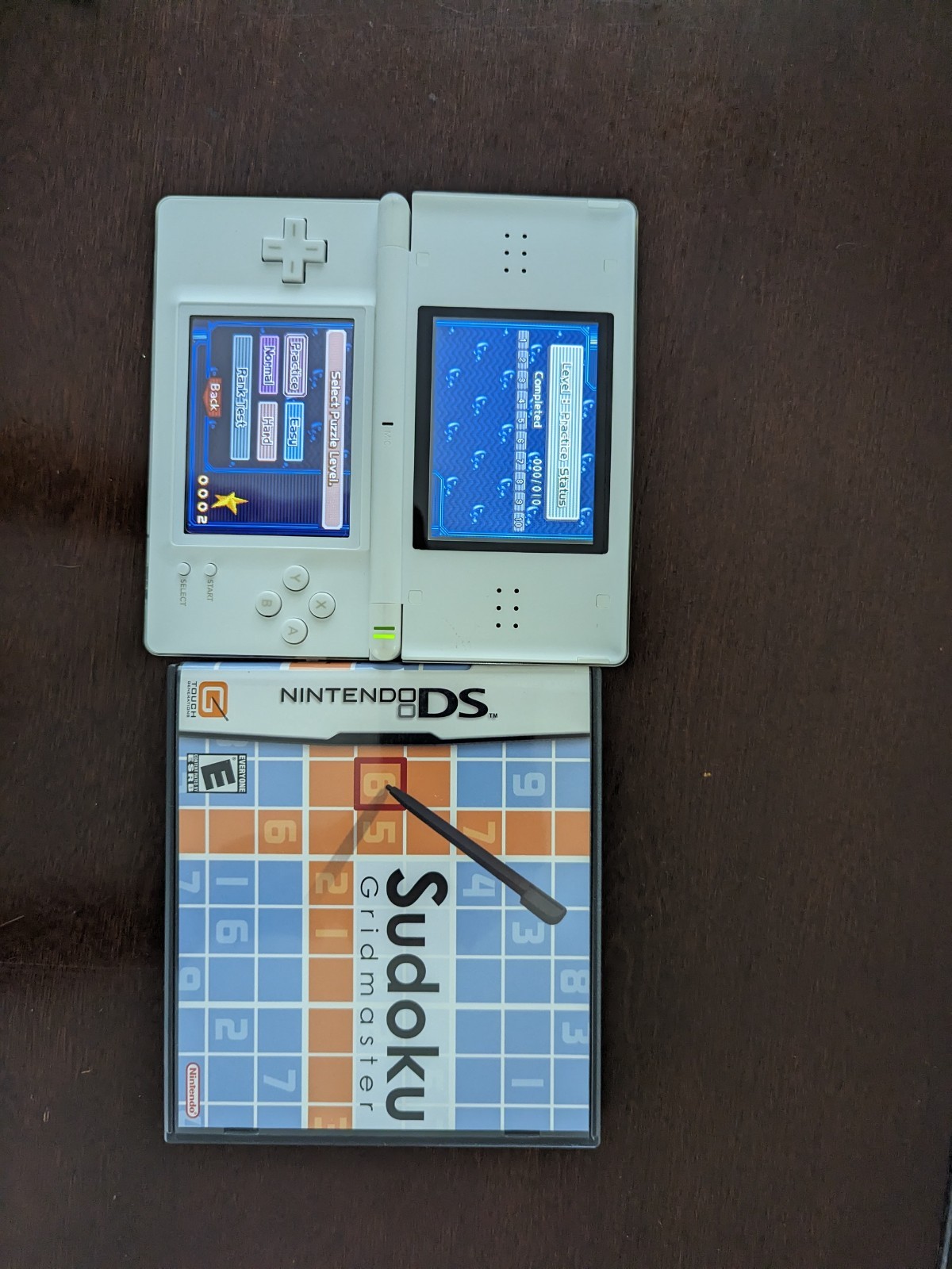 Nintendo DS Lite with Charger, Hard Case, soft case, 15 games in cases.