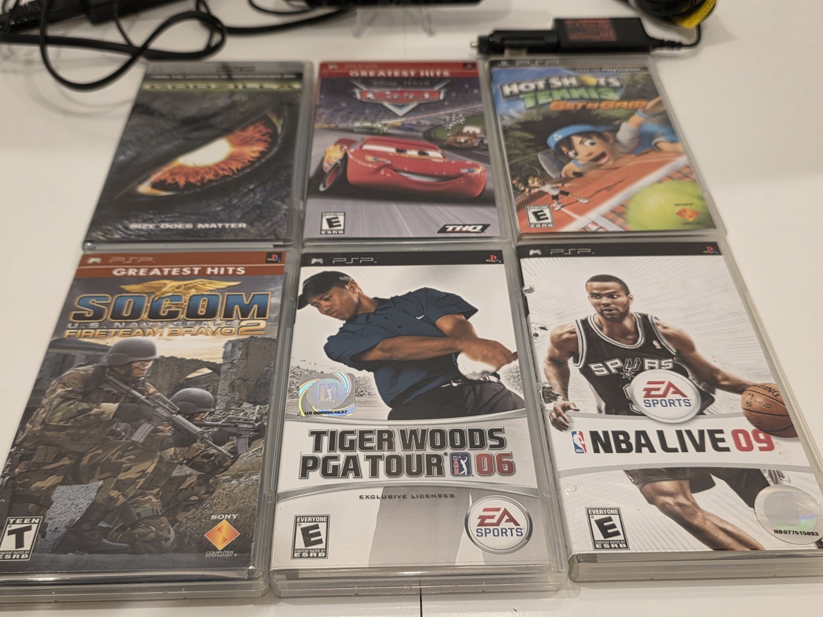 Sony PSP 3001 Black Handheld Console with Charger, Car Adapter, and 5 Games.