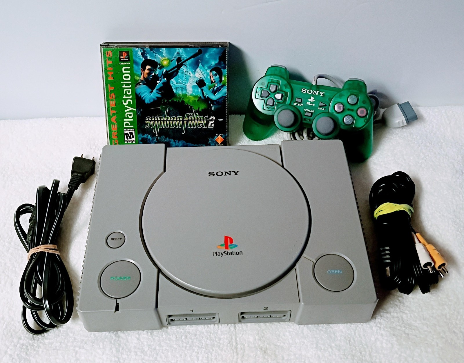 Playstation 1 with 1 controller, AV Cable, power cable and Syphon Filter 2 game