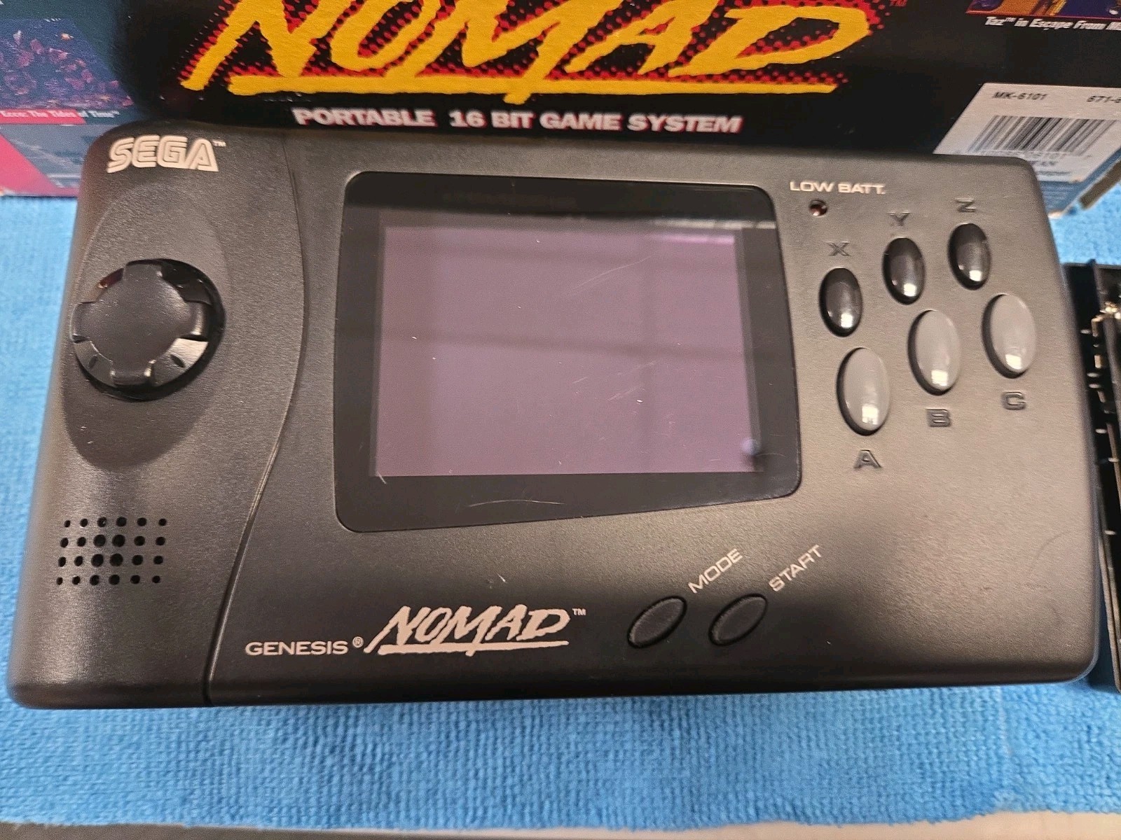 Sega Nomad Console. With Box (no inserts). A/C adaptor. Battery holder missing..