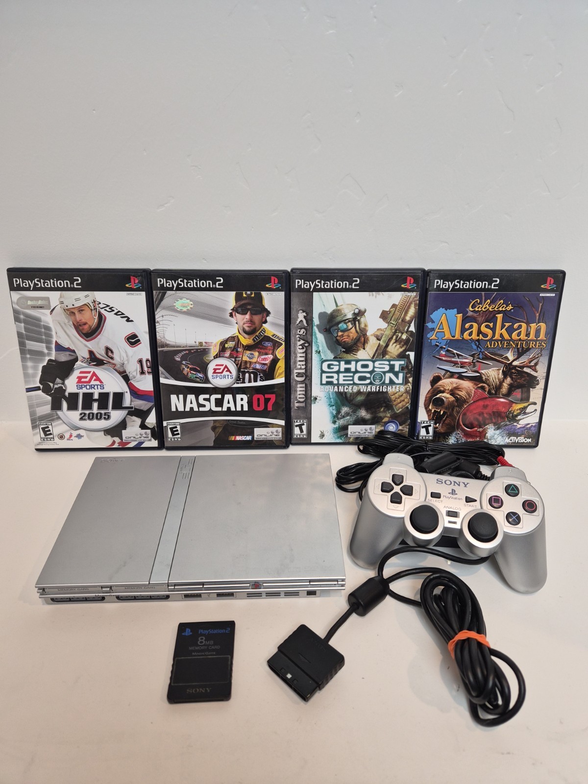 NEW LASER Silver PS2 Slim SCPH-77001 Bundle -NEW BATTERY – Cleaned 4 games Cords