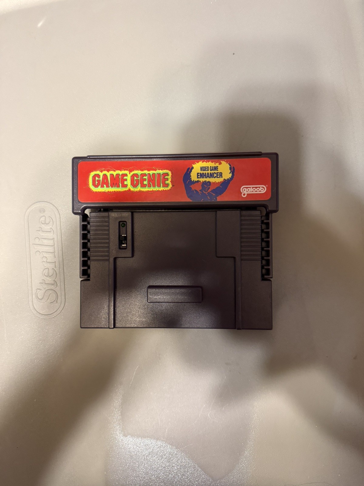 Super Nintendo Console, controller, game genie, and cleaning kit.