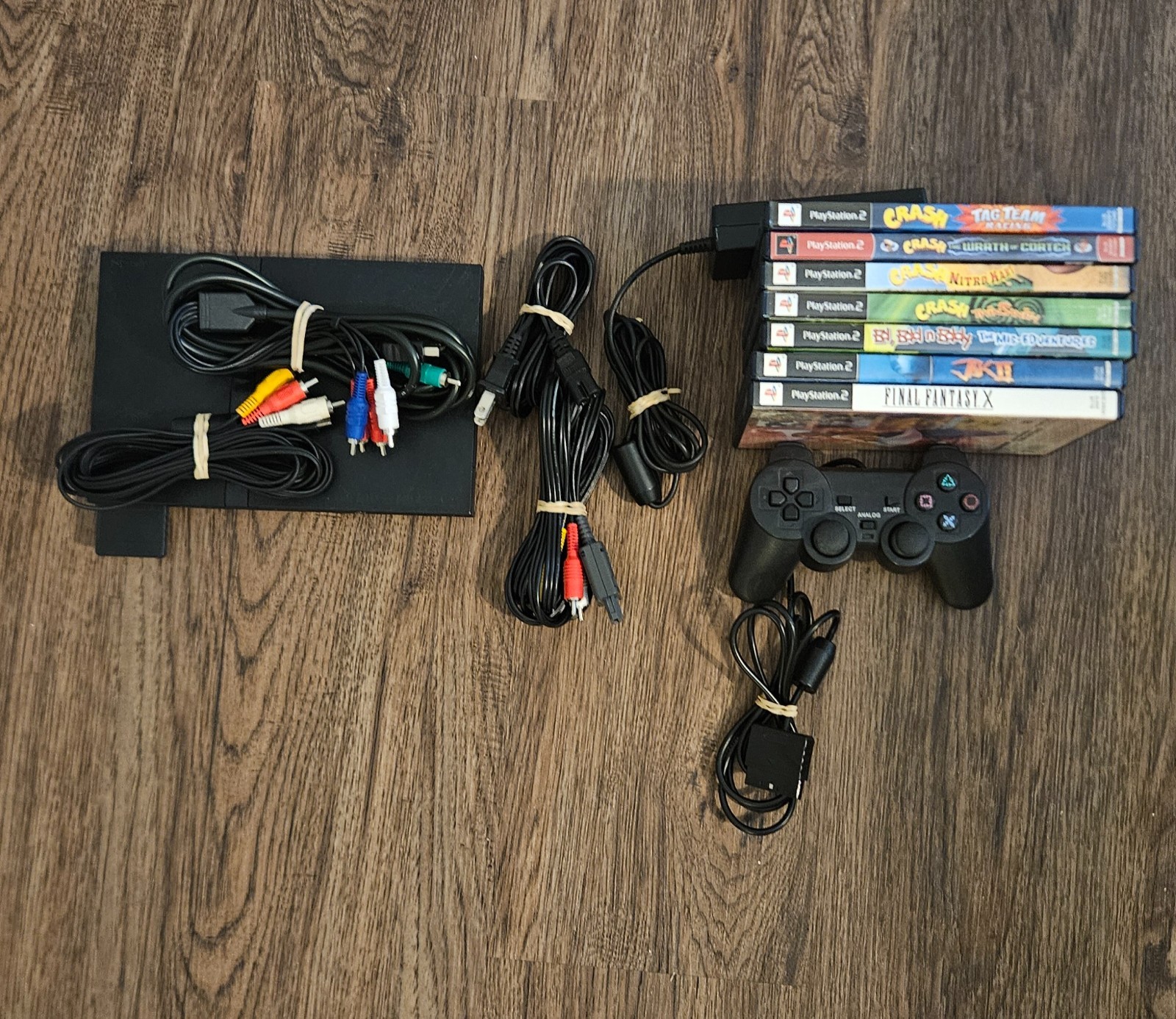 Sony PlayStation 2 Slim with controller, cables, and games