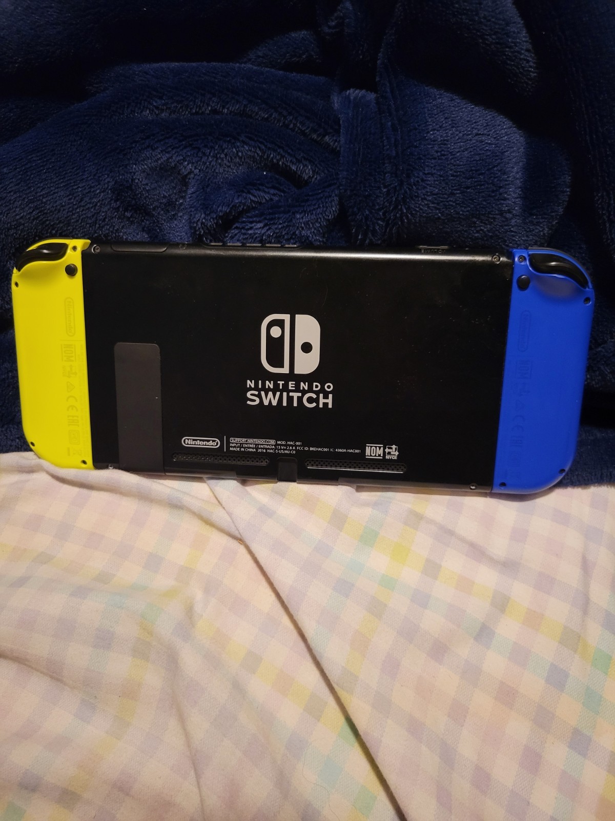Used Nintendo Handheld Switch Console – Black with Blue and Yellow Joycons