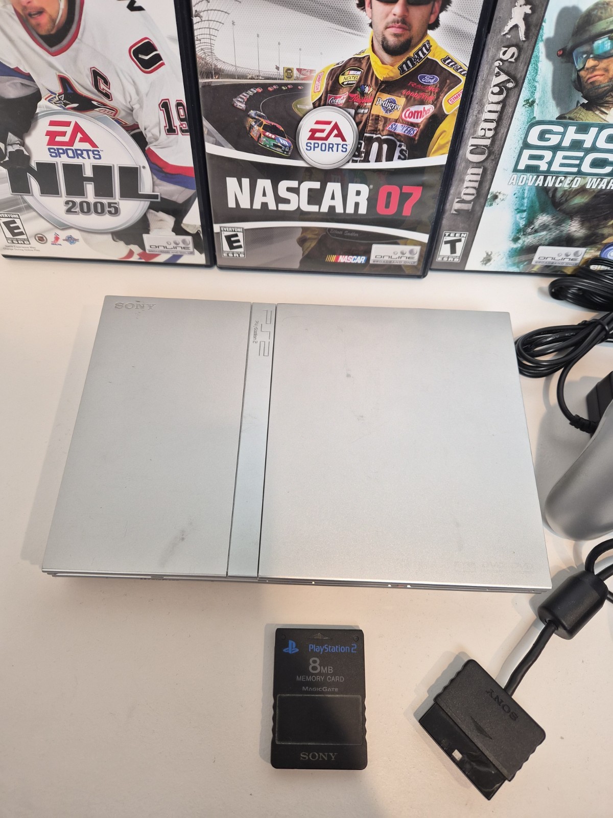 NEW LASER Silver PS2 Slim SCPH-77001 Bundle -NEW BATTERY – Cleaned 4 games Cords