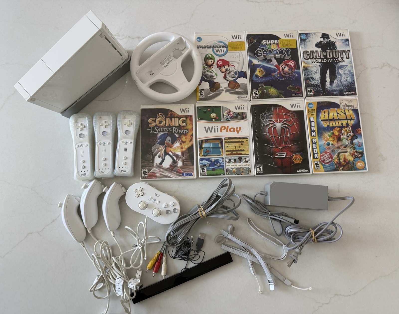 Nintendo Wii Bundle 7 Games, 3 Controllers, Nunchucks, Classic Controller Wheel