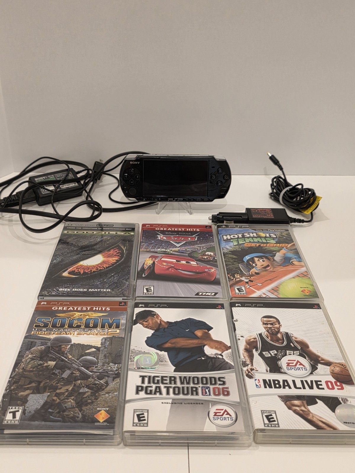 Sony PSP 3001 Black Handheld Console with Charger, Car Adapter, and 5 Games.