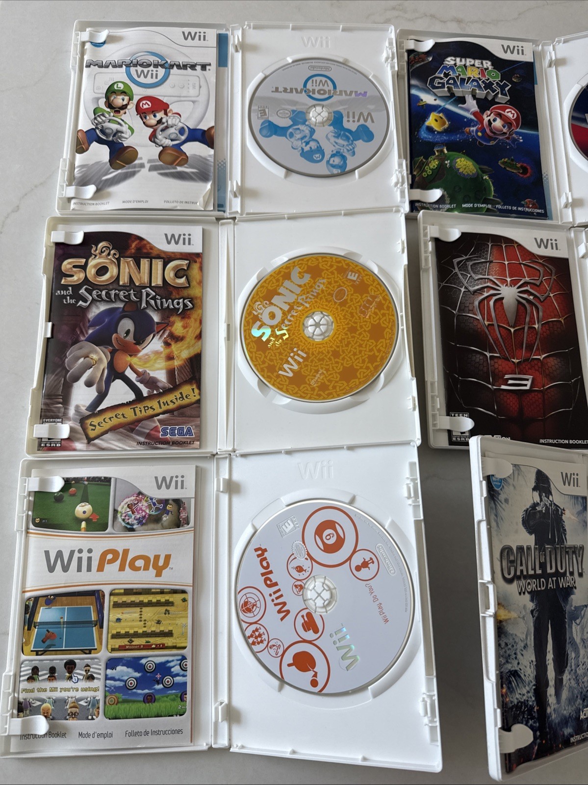 Nintendo Wii Bundle 7 Games, 3 Controllers, Nunchucks, Classic Controller Wheel