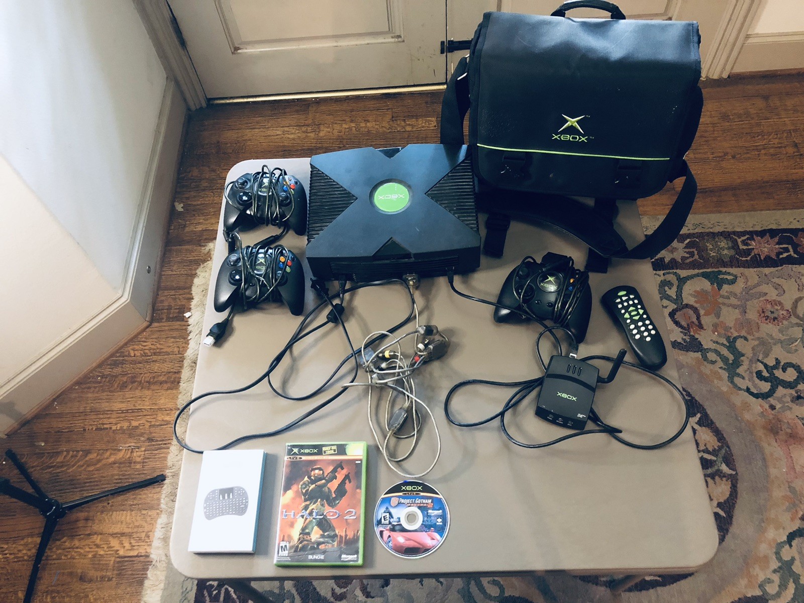 Xbox console, three controllers, carryting case, 2 games, and more