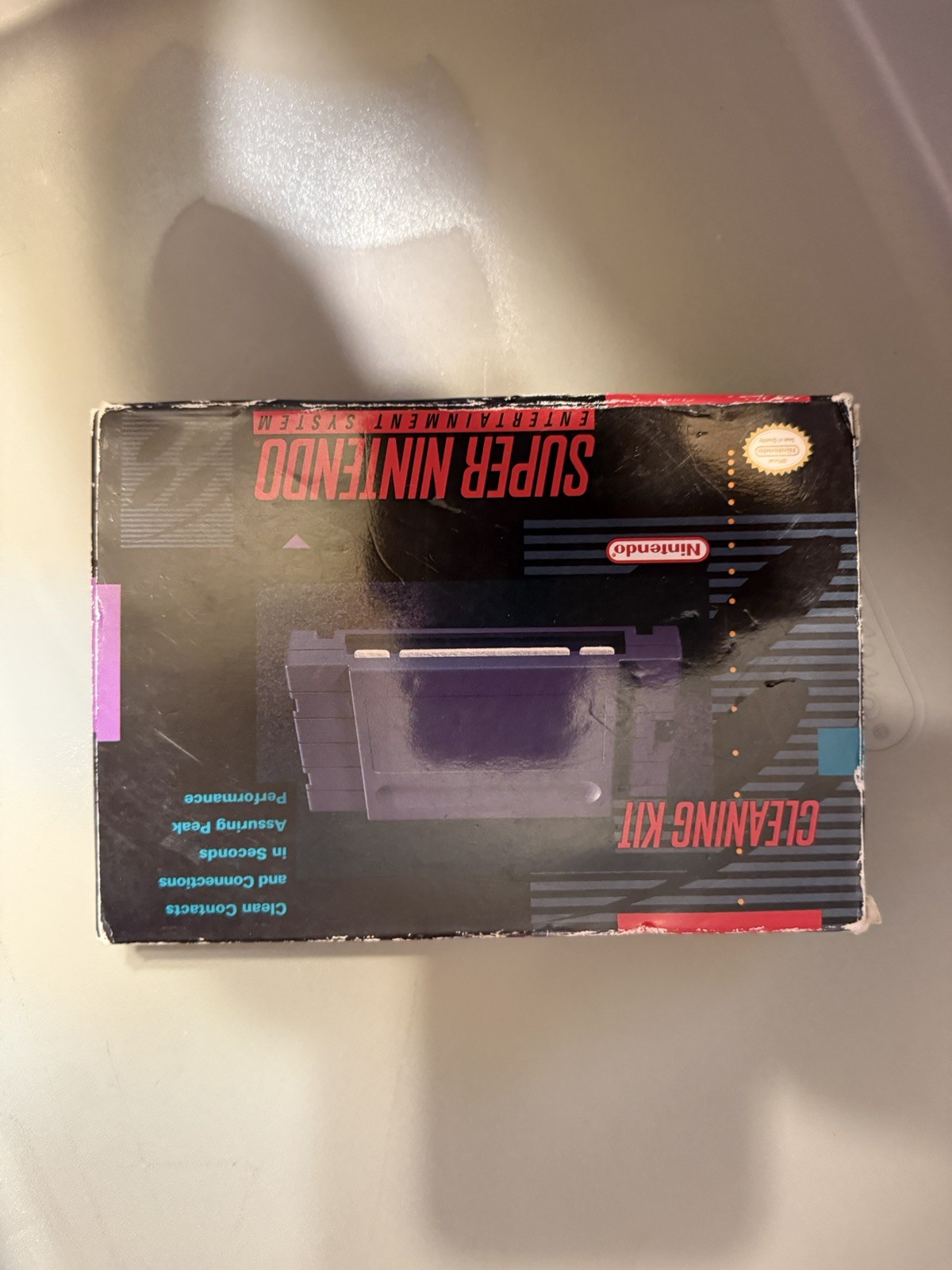 Super Nintendo Console, controller, game genie, and cleaning kit.