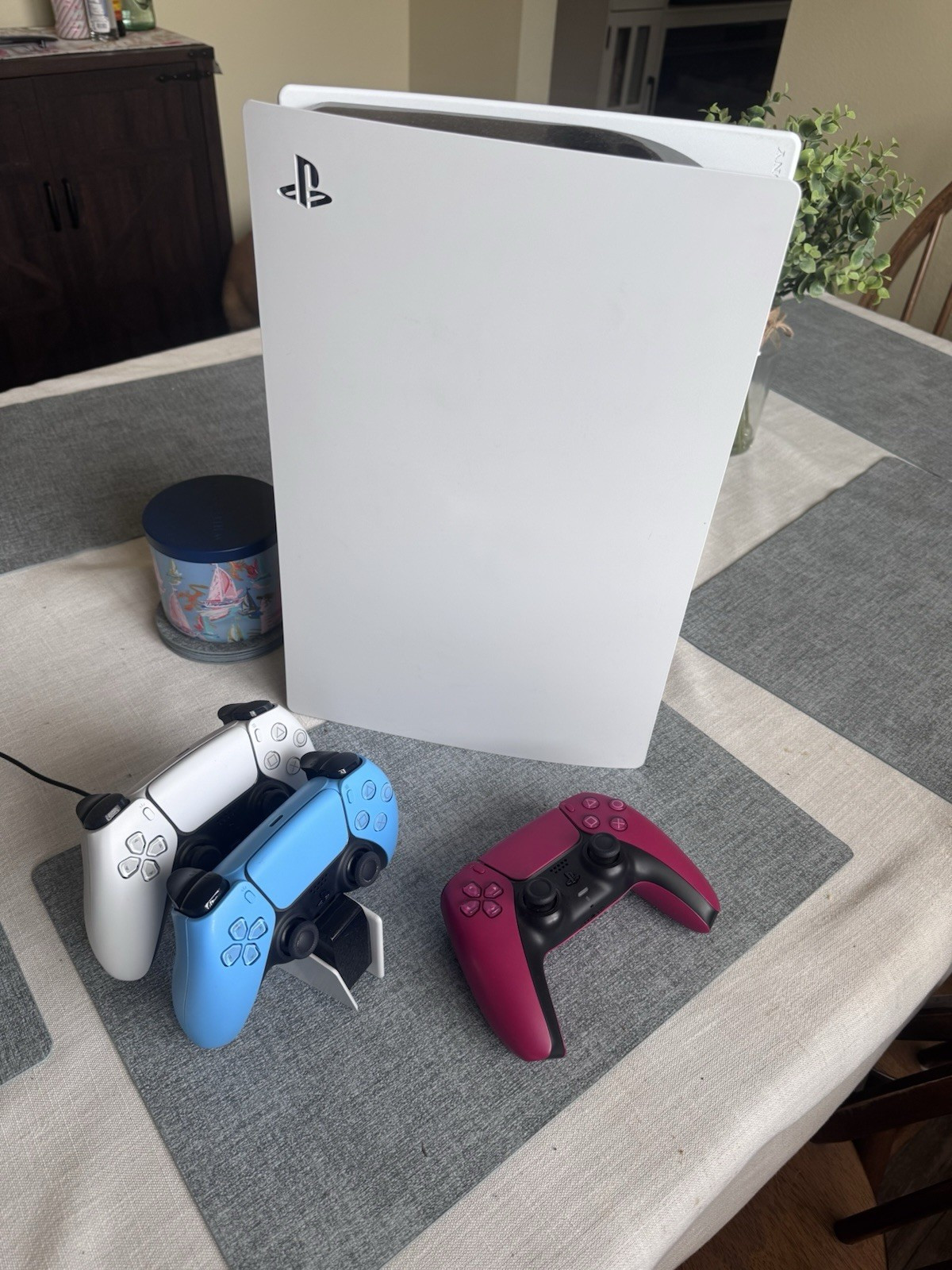 Digital PlayStation 5 Console With White, Blue, and Red Controllers.