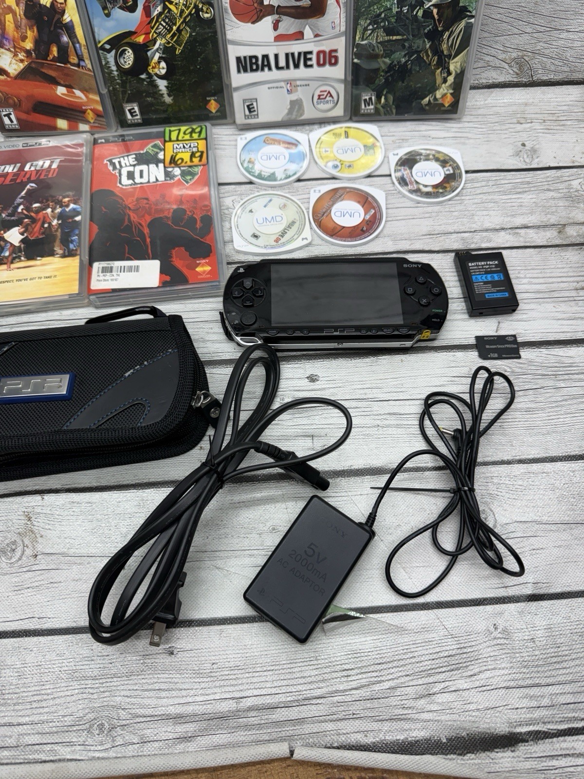 Sony PSP-1001 Black Console With Charger, 1GB Sony Storage Memory Card, 5 Games