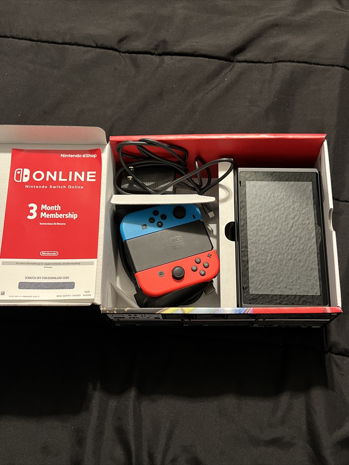 Nintendo Switch Blue and Red Joy-Con Controllers and Mario Kart 8
