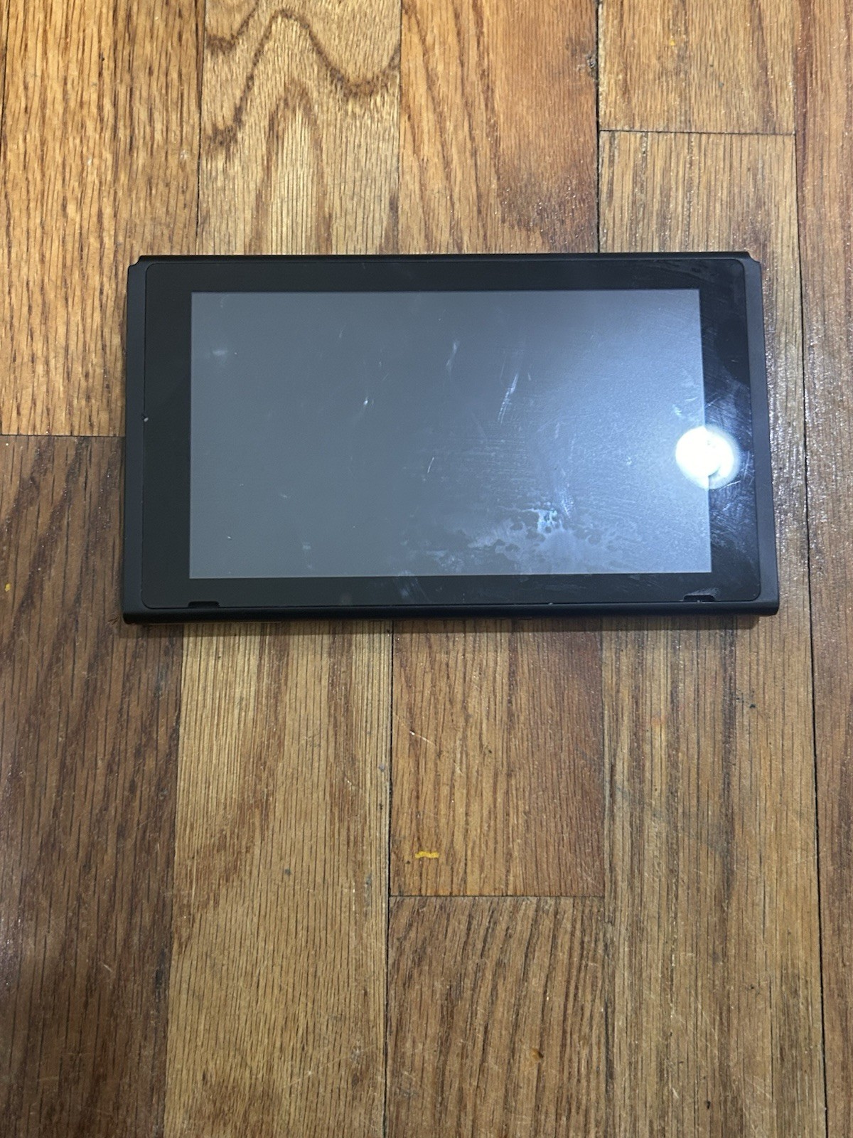Nintendo Switch with joycon controllers, a charger, 4 games, and a game case.