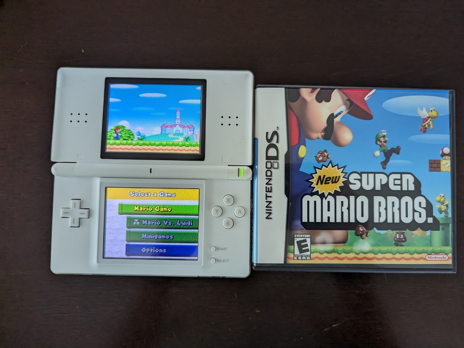 Nintendo DS Lite with Charger, Hard Case, soft case, 15 games in cases.
