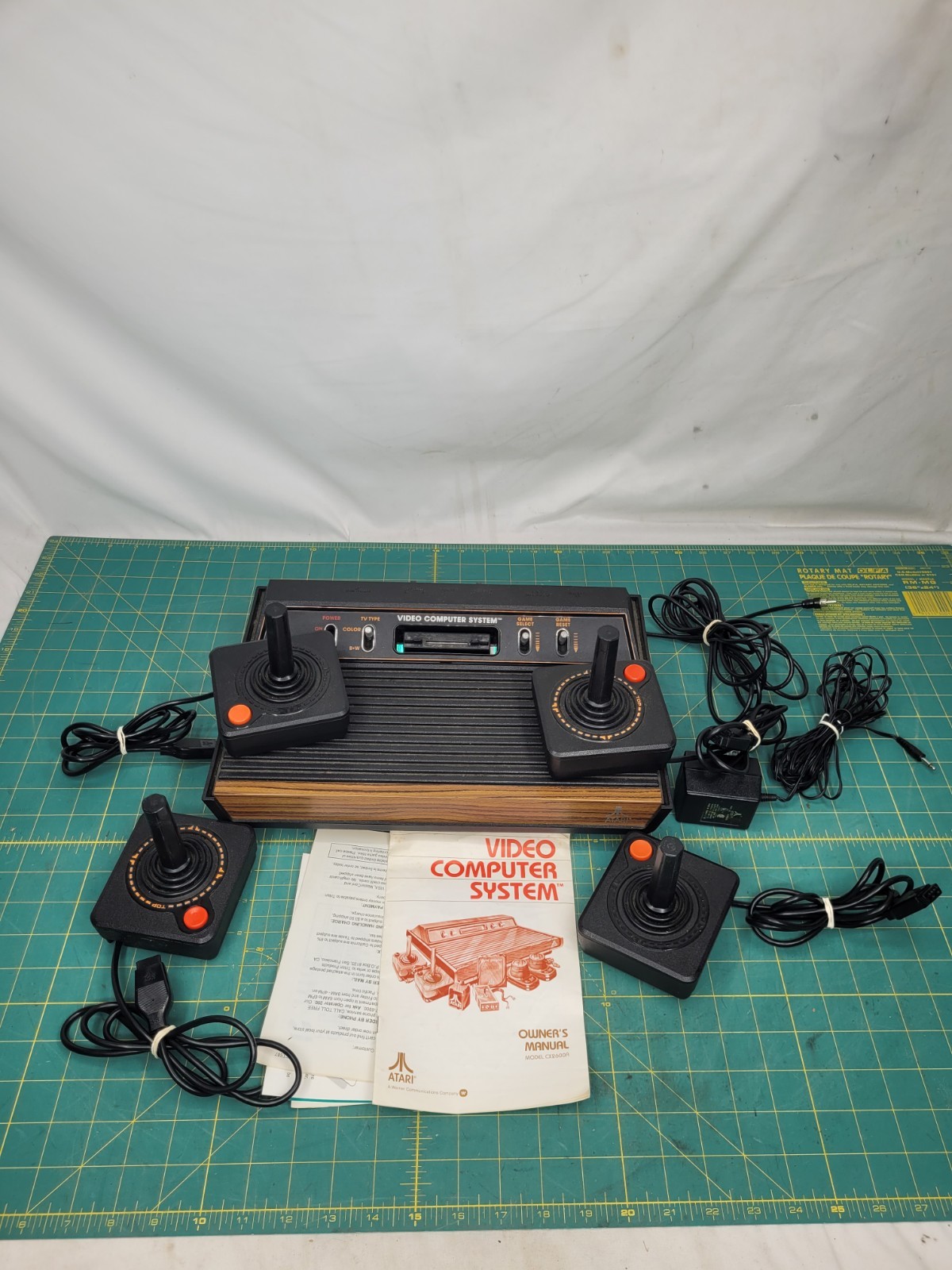 Atari 2600 console With Cords And 4 Joystick Controllers Powers On Needs Work